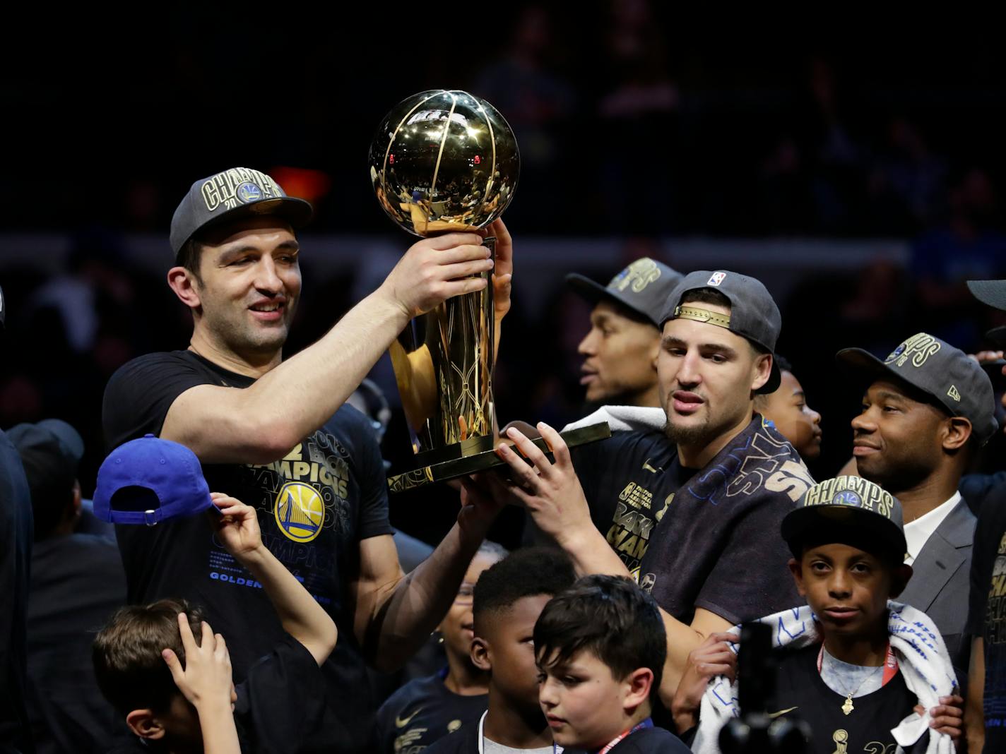 Golden State's Zaza Pachulia, left, and Klay Thompson held the NBA championship trophy after the Warriors defeated the Cleveland Cavaliers 108-85 in Game 4 of the NBA Finals earlier this month.