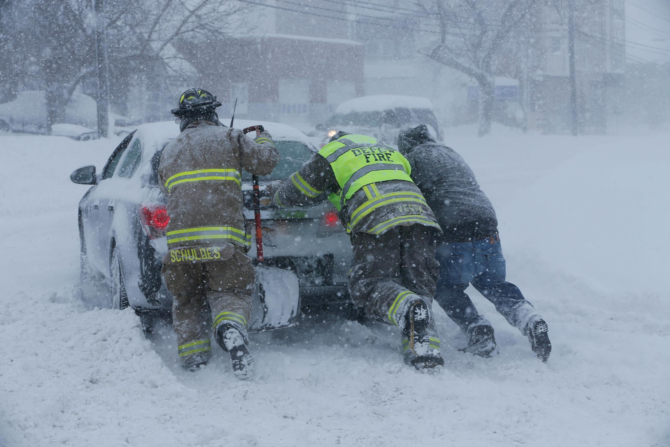 Firefighters from West End Hose Company in Depew, N.Y. help a stuck motorist on Transit Road, Tuesday, Nov. 18, 2014.