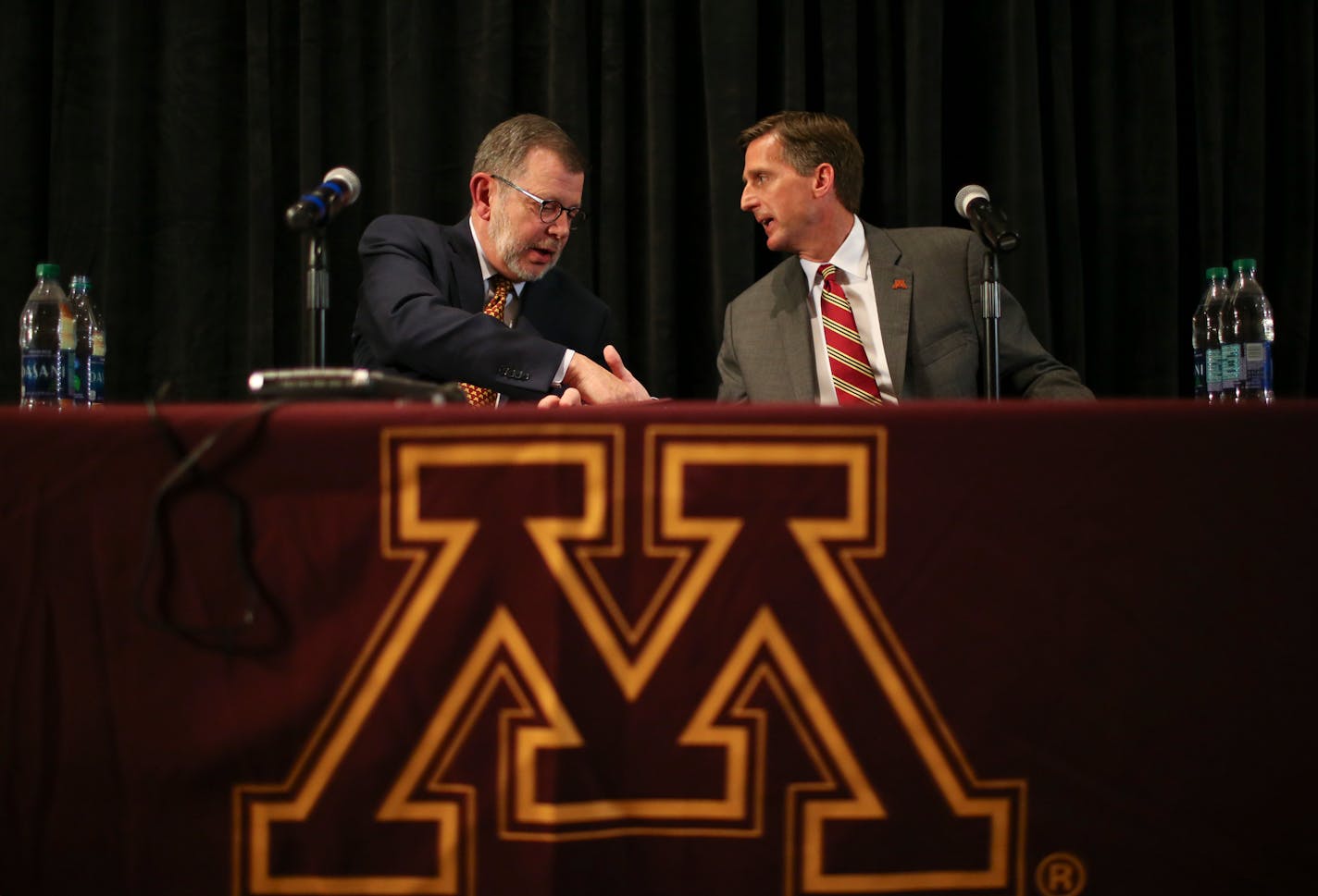 Mark Coyle shook hands with U of M President Eric Kaler.