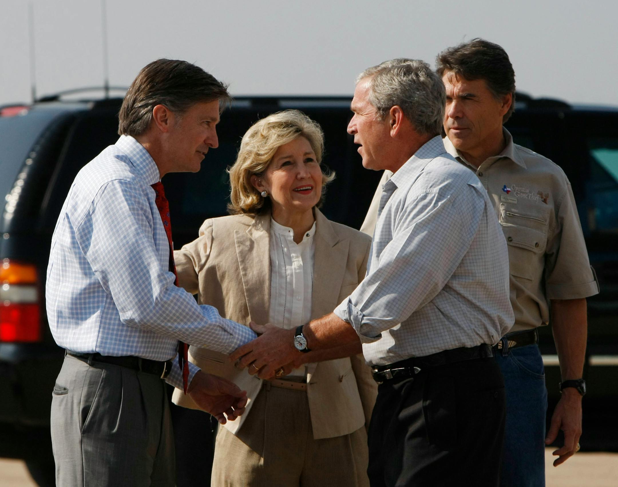 President Bush, second from the right, is greeted by Will Wynn, Mayor of Austin, Texas, Sen. Kay Bailey Hutchison, R-Texas, and Texas Gov. Rick Perry, during his arrival at Austin-Bergstrom International Airport in Austin, Texas.