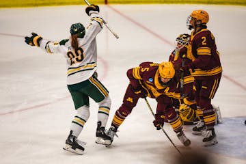 Clarkson's Dominique Petrie (29) celebrates her winning goal in the fourth overtime against the Gophers women's hockey team to end the NCAA quarterfin