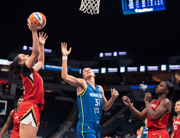 Las Vegas Aces forward Dearica Hamby (5) shoots next to Minnesota Lynx center Nikolina Milic (31) during a WNBA basketball game Friday, July 1, 2022, 
