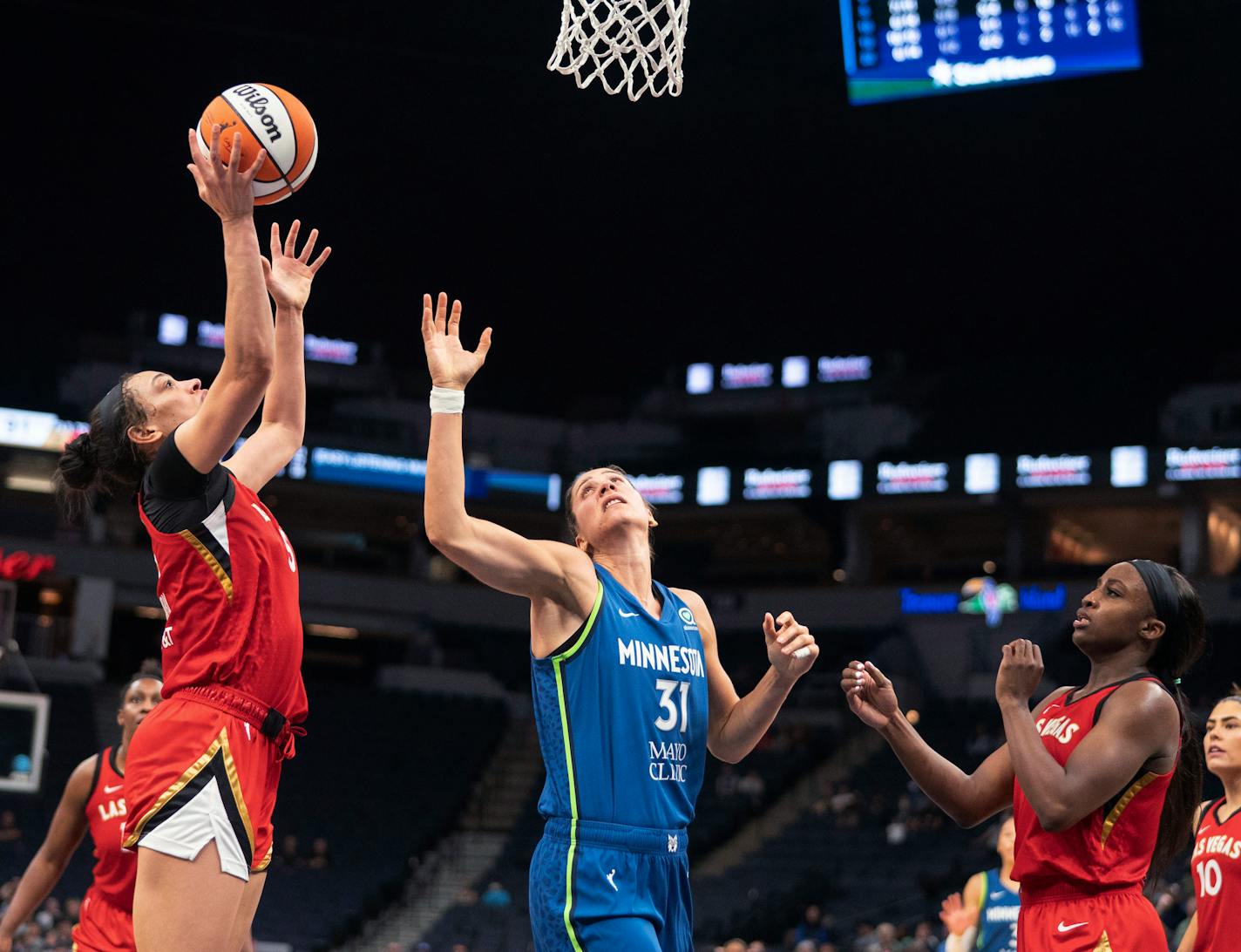 Las Vegas Aces forward Dearica Hamby (5) shoots next to Minnesota Lynx center Nikolina Milic (31) during a WNBA basketball game Friday, July 1, 2022, in Minneapolis. (Erica Dischino/Star Tribune via AP)