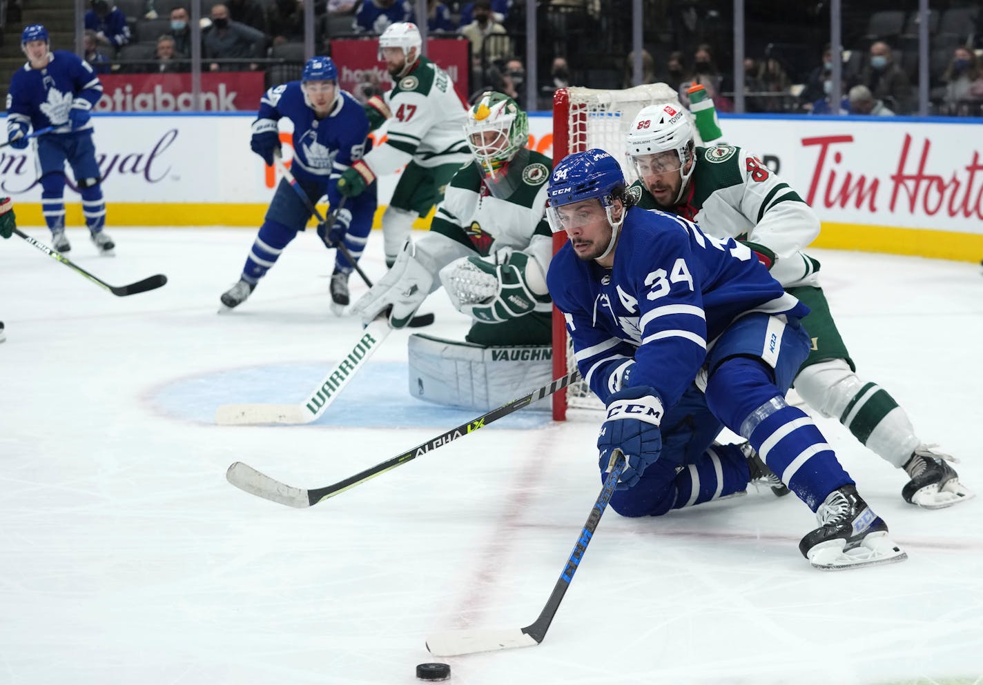 Toronto Maple Leafs center Auston Matthews controls the puck to the side of Wild goaltender Kaapo Kahkonen during the second period Thursday