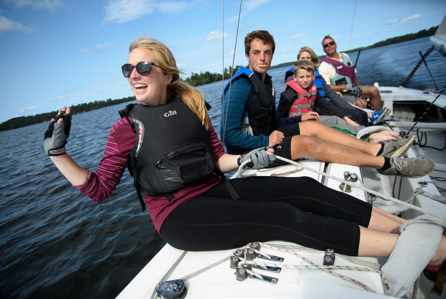 Cara Hanson, daughter of Pehrson Lodge Resort owner Eric Hanson, waved to a passing fishing boat while out on an afternoon sailing trip on Lake Vermilion.