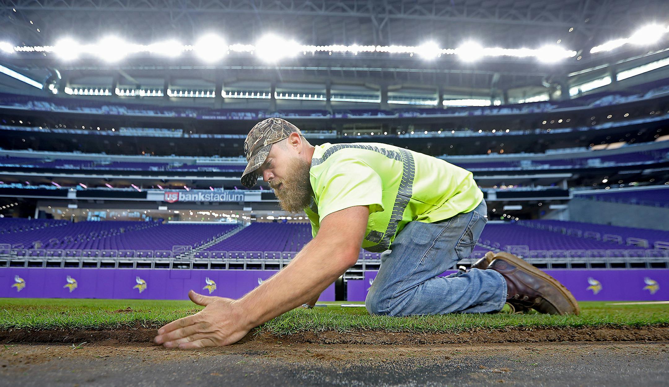 Mike Carlson, who works for Minnesota Sodding Company, placed turf onto the U.S. Bank Stadium field.