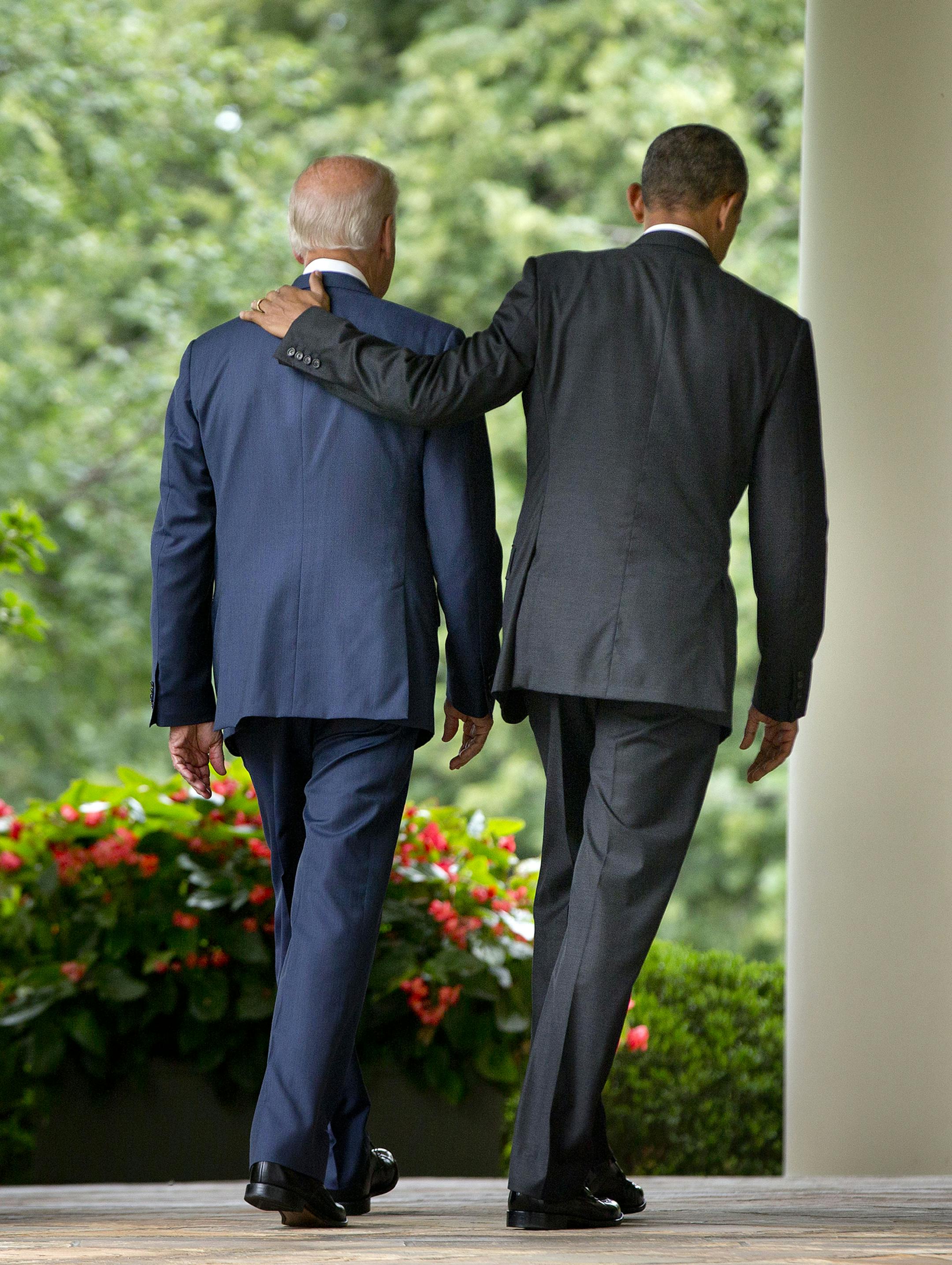 President Barack Obama walks with Vice President Joe Biden back to the Oval Office of the White House in Washington, Thursday, June 25, 2015, after speaking in the Rose Garden after the Supreme Court upheld the subsidies for customers in states that do not operate their own exchanges under President Barack Obama's Affordable Care Act. (AP Photo/Pablo Martinez Monsivais)