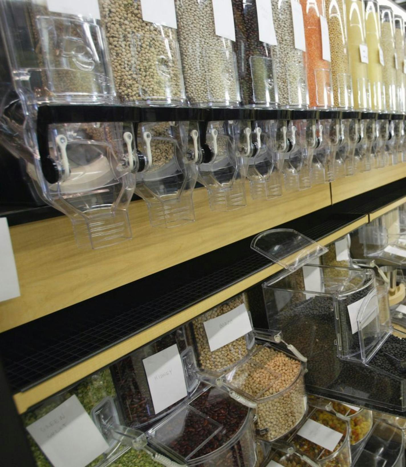 Grocery manager Jason Lund checks the black beans in the bulk dried beans and grains section of the co-op.
GENERAL INFORMATION: Minneapolis, Mn., Mon., Nov. 24, 2003--Eastside Food Co-op stocks up in preparation for Dec. 3 opening.