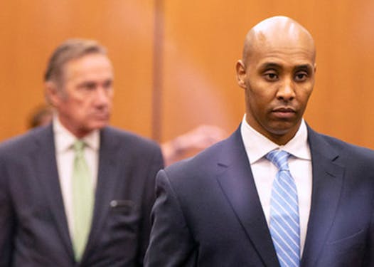 Former Minneapolis police officer Mohamed Noor walks through Hennepin County Government Center with his legal team in 2019.