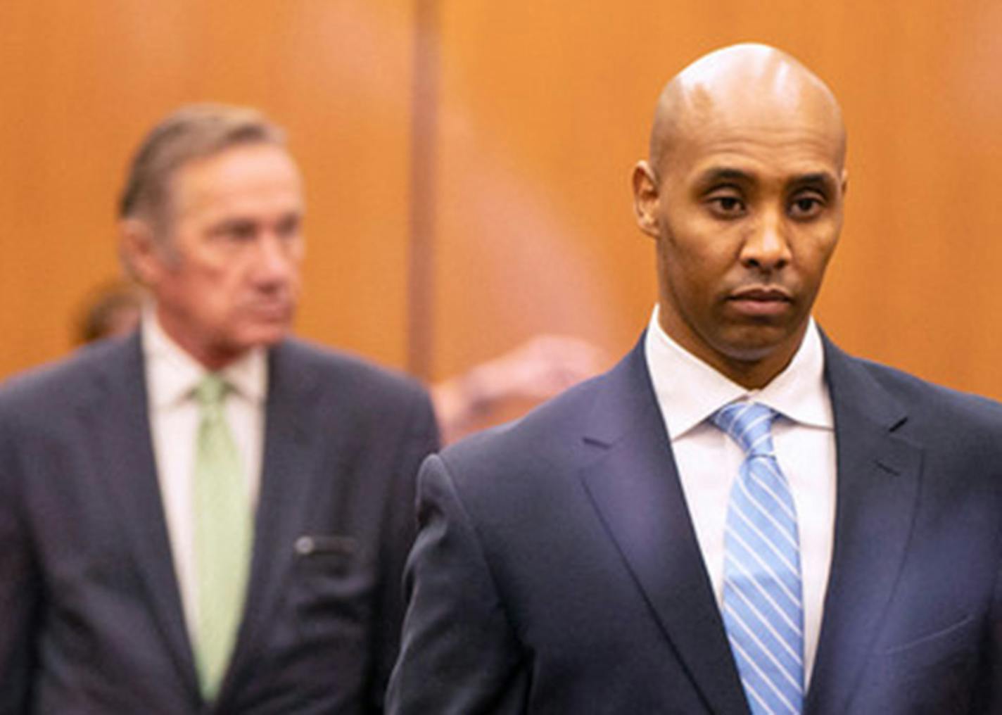 Former Minneapolis police officer Mohamed Noor walked through the elevator lobby of the Hennepin County Government Center with his legal team on Friday.