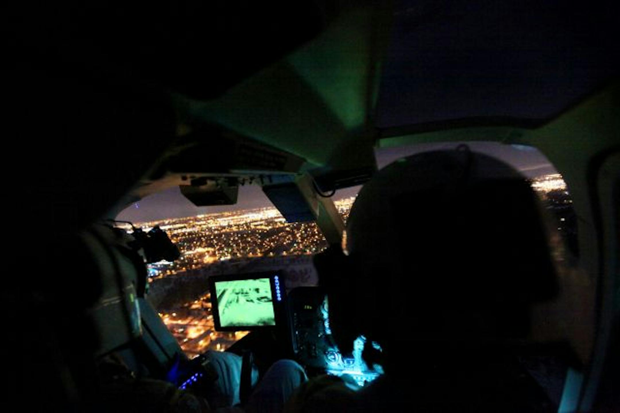 State Patrol pilots David Latt and Greg Burgess fly over the metro area on a call looking for a man who was missing after being stabbed recently. The green screen is the infrared system the officers were using to look for footprints or people in the snow.
