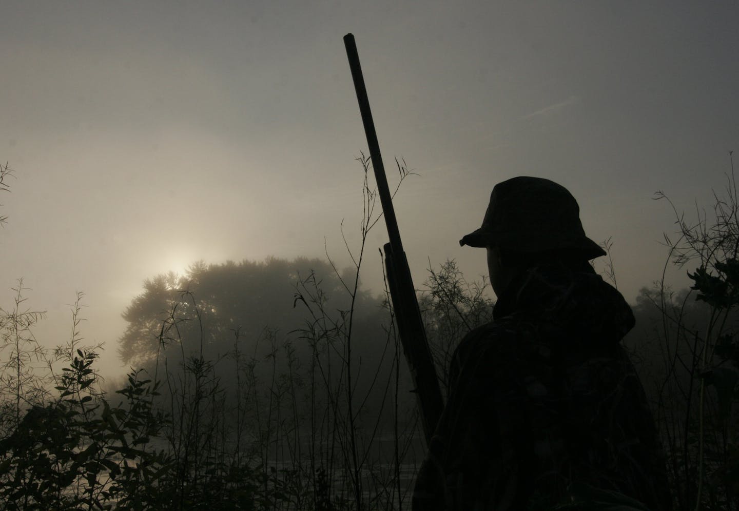 Sam Olson, 14, of Minnetonka, scans the sky for ducks at dawn during Youth Waterfowl Day at the Minnesota Valley National Wildlife Refuge near Shakopee.