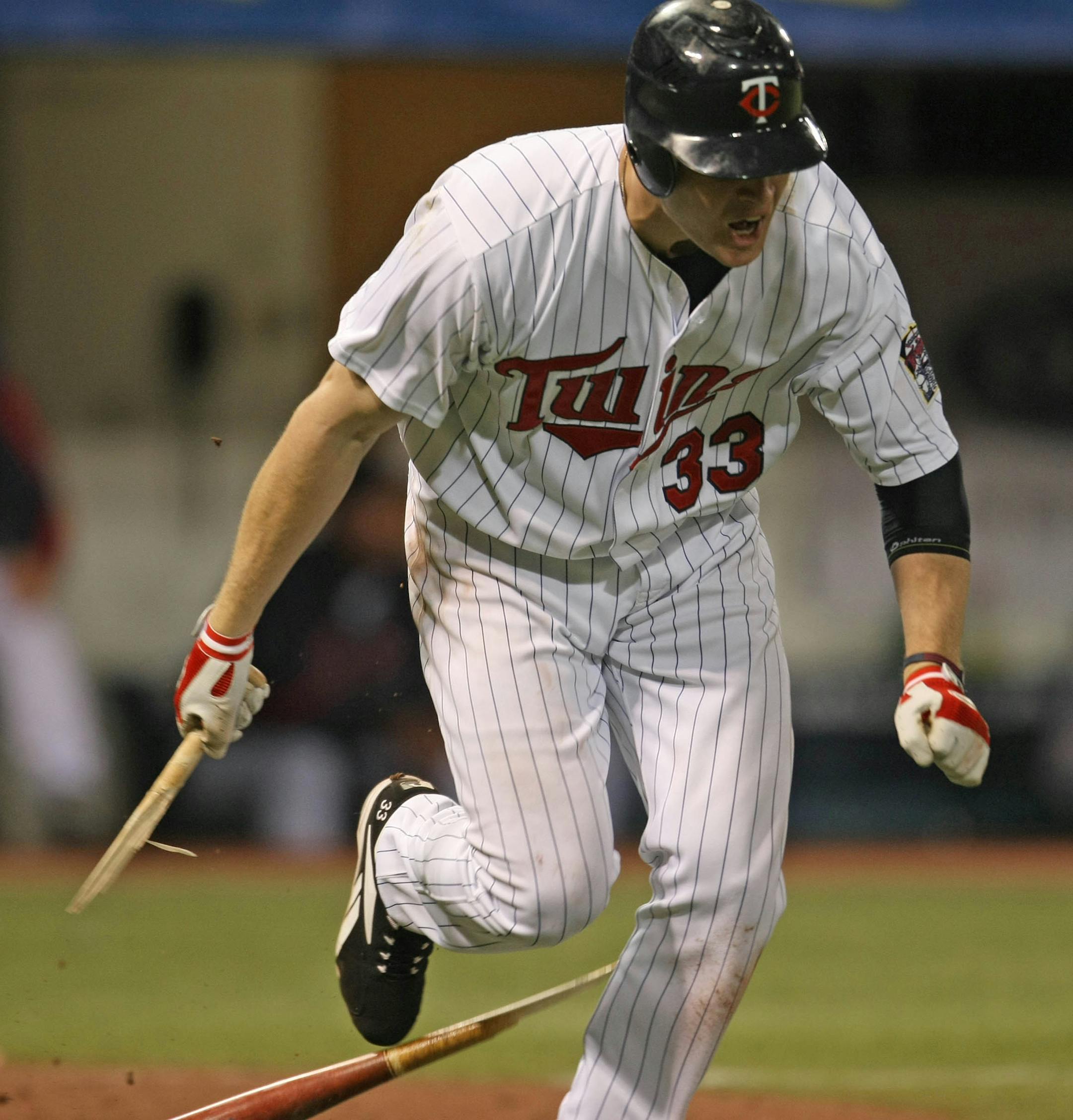 Justin Morneau broke his bat in frustration as he ran to first after popping out to end the 9th inning.