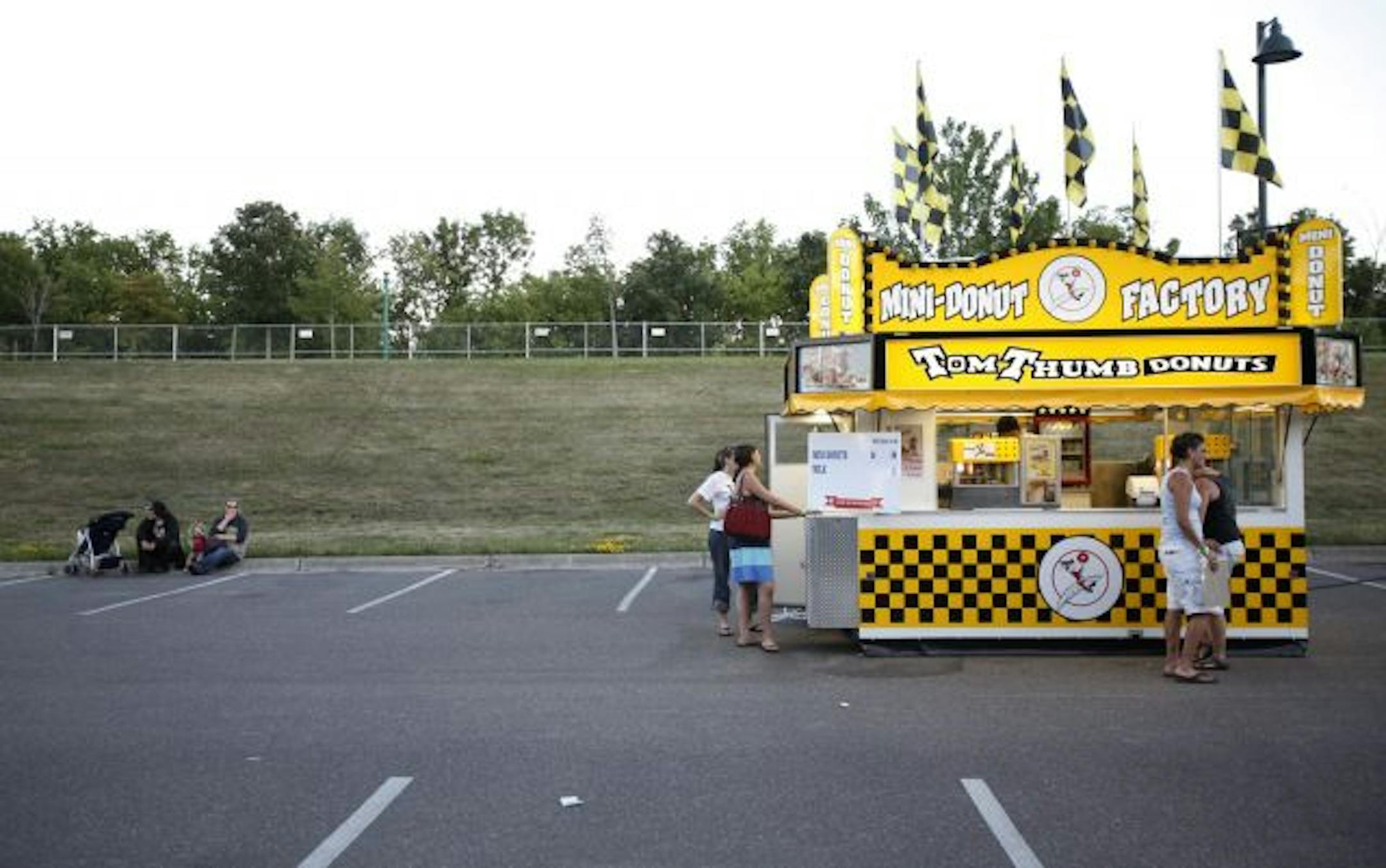Hungry patrons place thier order at the Tom Thumb Donut stand at the 2009 Taste of Minnesota Thursday evening on Harriet Island in St. Paul.