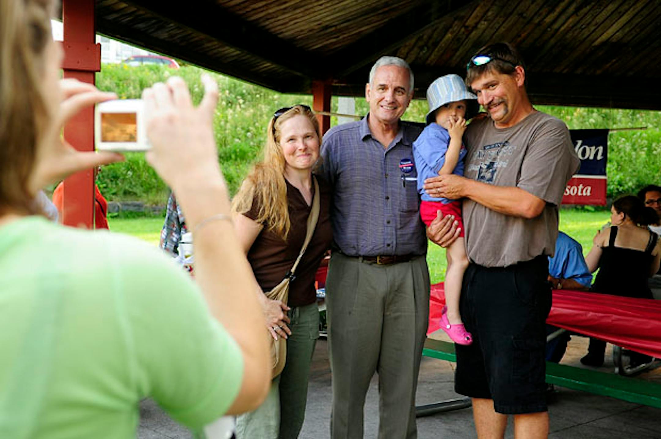 Gov. Mark Dayton had his picture taken by an unidentified photographer and family during a Fall 2010 campaign stop in Duluth. Howie Hanson / For StarTribune.com