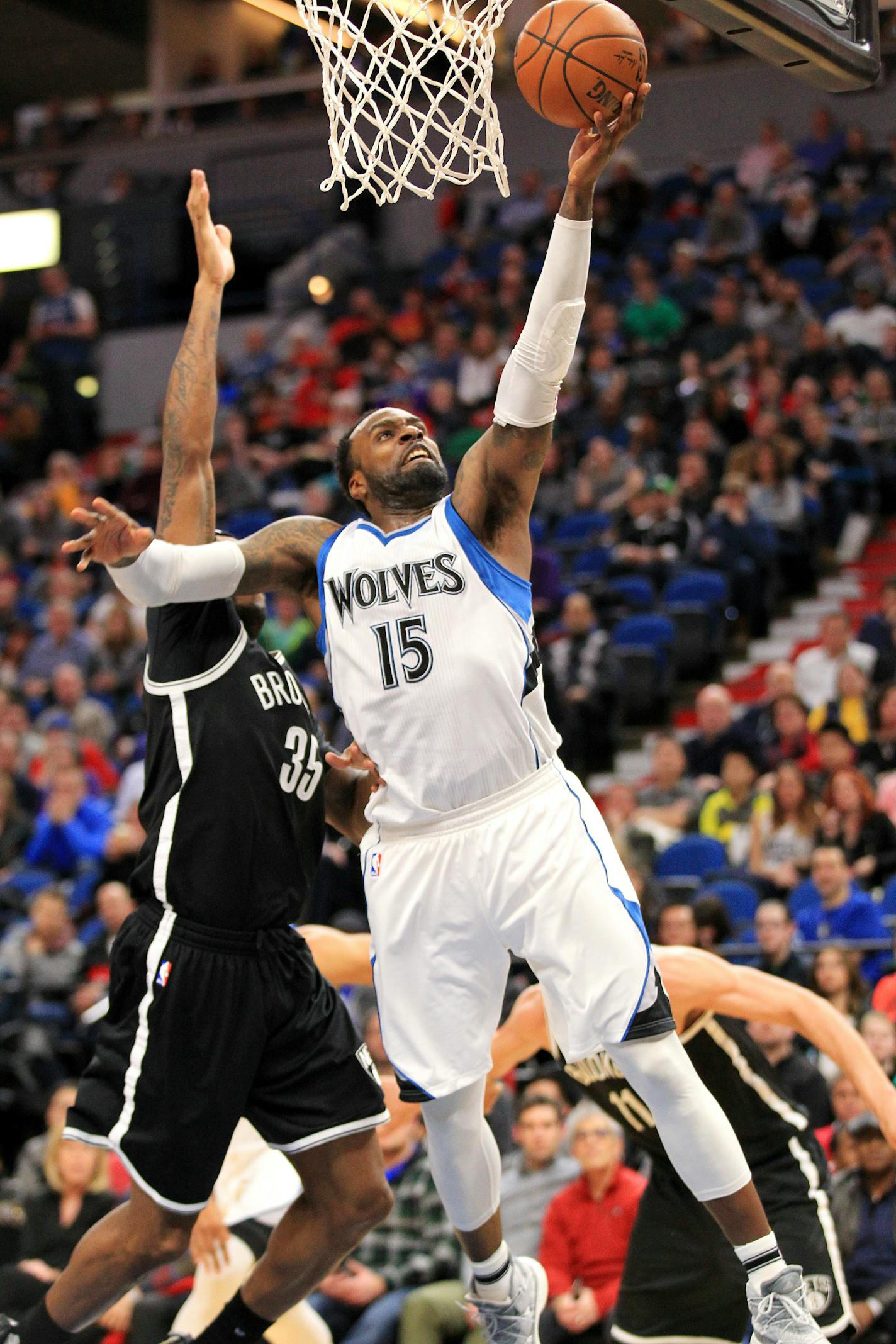 Minnesota Timberwolves forward Shabazz Muhammad (15) shoots in front of Brooklyn Nets forward Trevor Booker (35) during the fourth quarter of an NBA basketball game in Minneapolis, Saturday, Jan. 28, 2017. The Timberwolves defeated the Nets 129-109.(AP Photo/Andy Clayton-King)