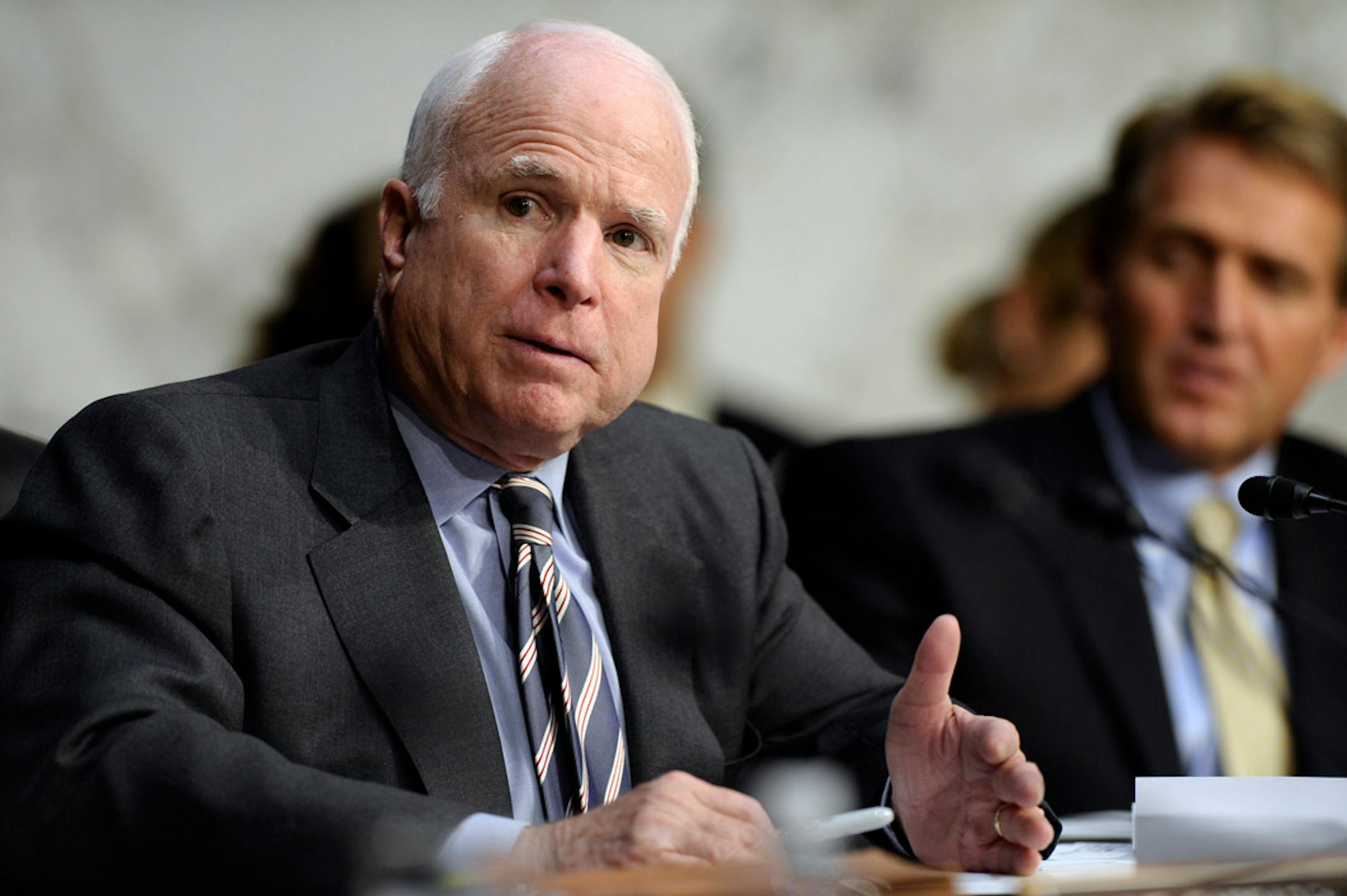 Senate Foreign Relations Committee member Sen. John McCain, R-Ariz., left, speaks on Capitol Hill in Washington, Wednesday, Sept. 4, 2013, during the committee's hearing to consider the authorization for use of military force in Syria. Sen. Jeff Flake, R-Ariz. is at right.