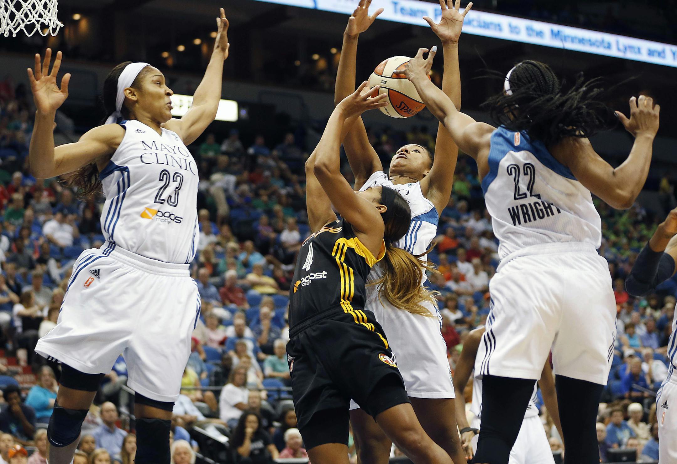 Minnesota Lynx guard Monica Wright (22) blocks the shot of Tulsa Shock guard Skylar Diggins (4) in the second half of a WNBA basketball game, Wednesday, July 16, 2014, in Minneapolis. The Lynx won 93-82. (AP Photo/Stacy Bengs)