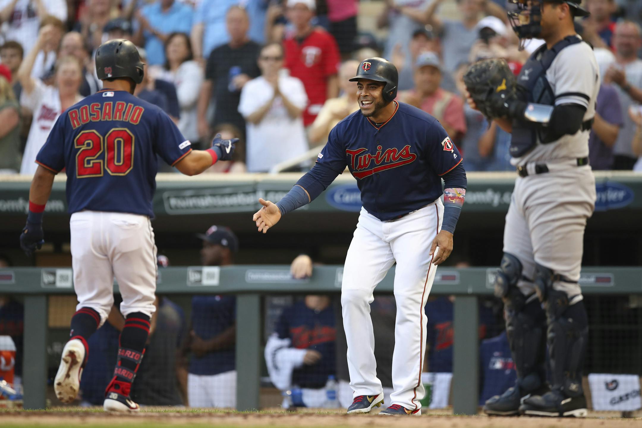 Eddie Rosario of the Twins was greeted at home by Nelson Cruz after homering off Yankees pitcher J.A. Happ on July 24.