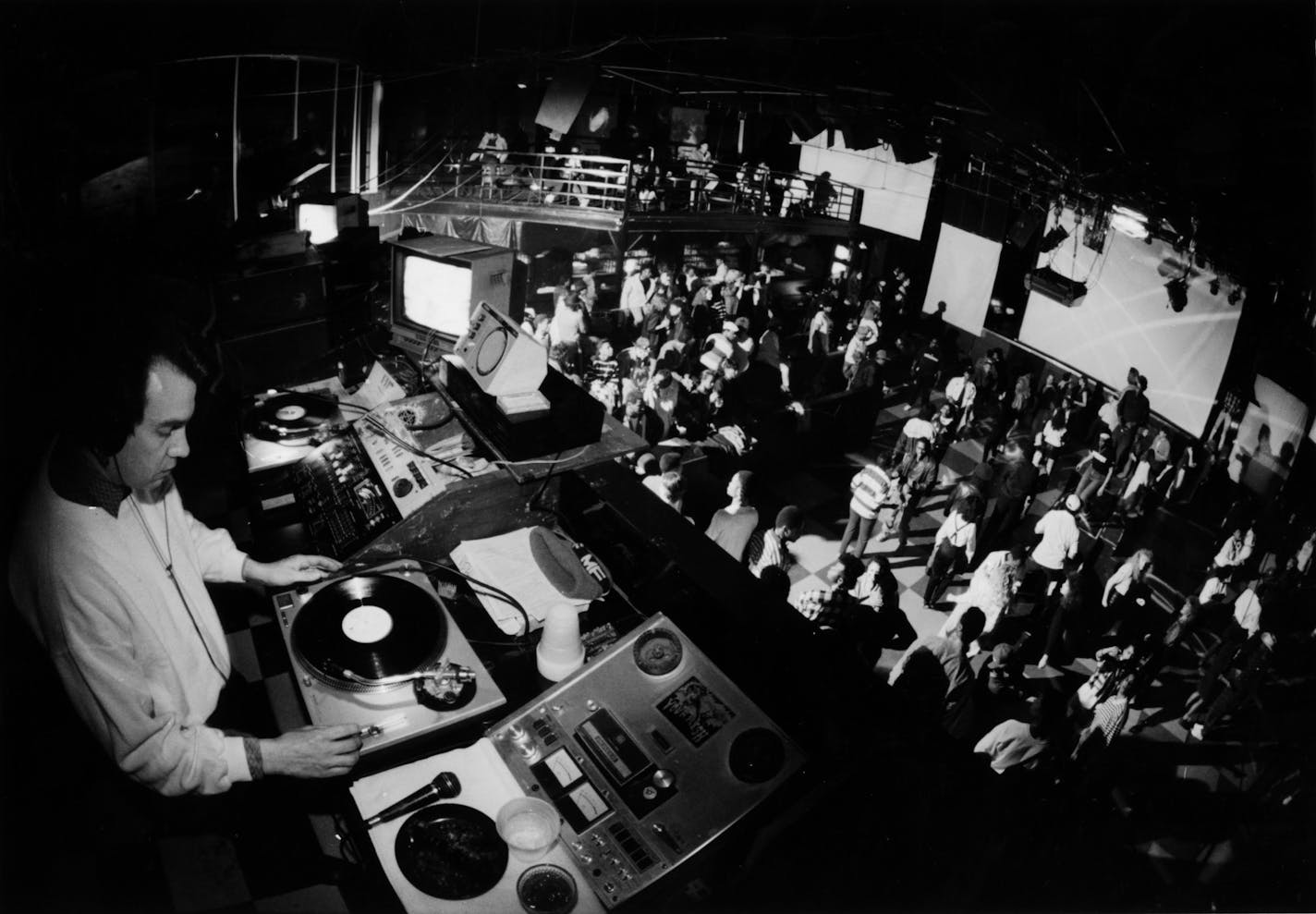 A deejay spins the records at First Avenue (rock music nightclub) in downtown Minneapolis. February 1988 photo by Star Tribune staff photographer David Brewster. Brewster's notes are as follows: DJ Roy Freedom spinning discs for funk night "MORE FUNK"