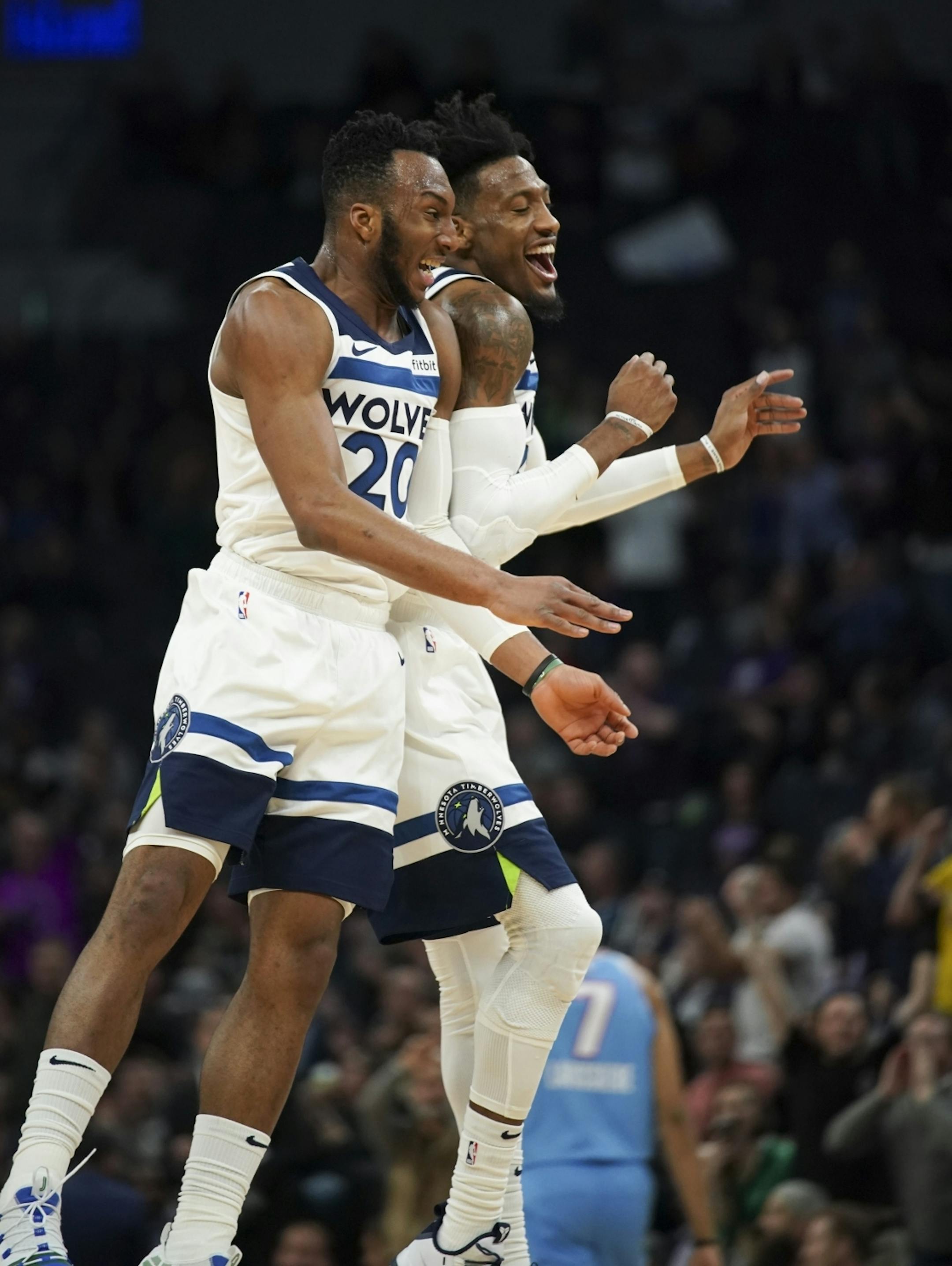 Minnesota Timberwolves forward Robert Covington (33) and Minnesota Timberwolves guard Josh Okogie (20) celebrated a sweet basket by Okogie in the second quarter.