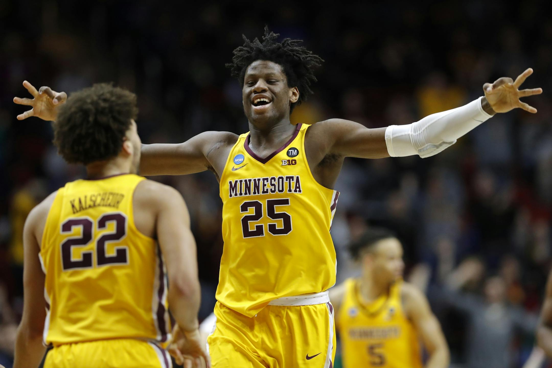 Minnesota center Daniel Oturu (25) celebrates with teammate Gabe Kalscheur (22) during a first round men's college basketball game against Louisville in the NCAA Tournament, Thursday, March 21, 2019, in Des Moines, Iowa.