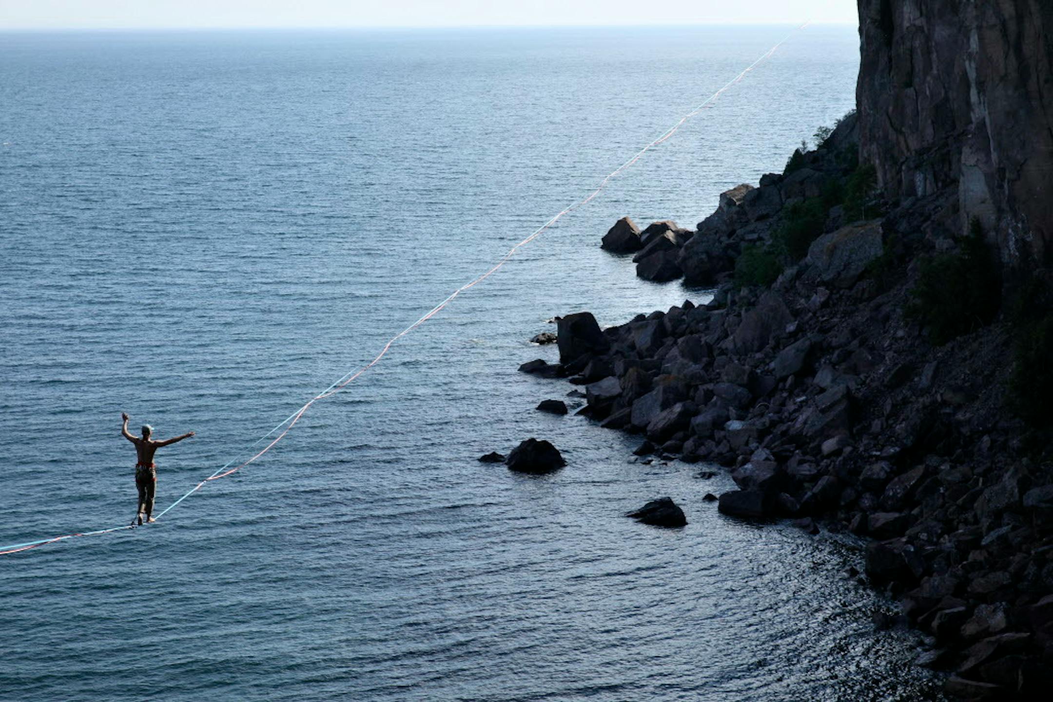 Slackliner Mark Mckee and Michael Nichols walk the line 300 feet above the water at Palisade Head.