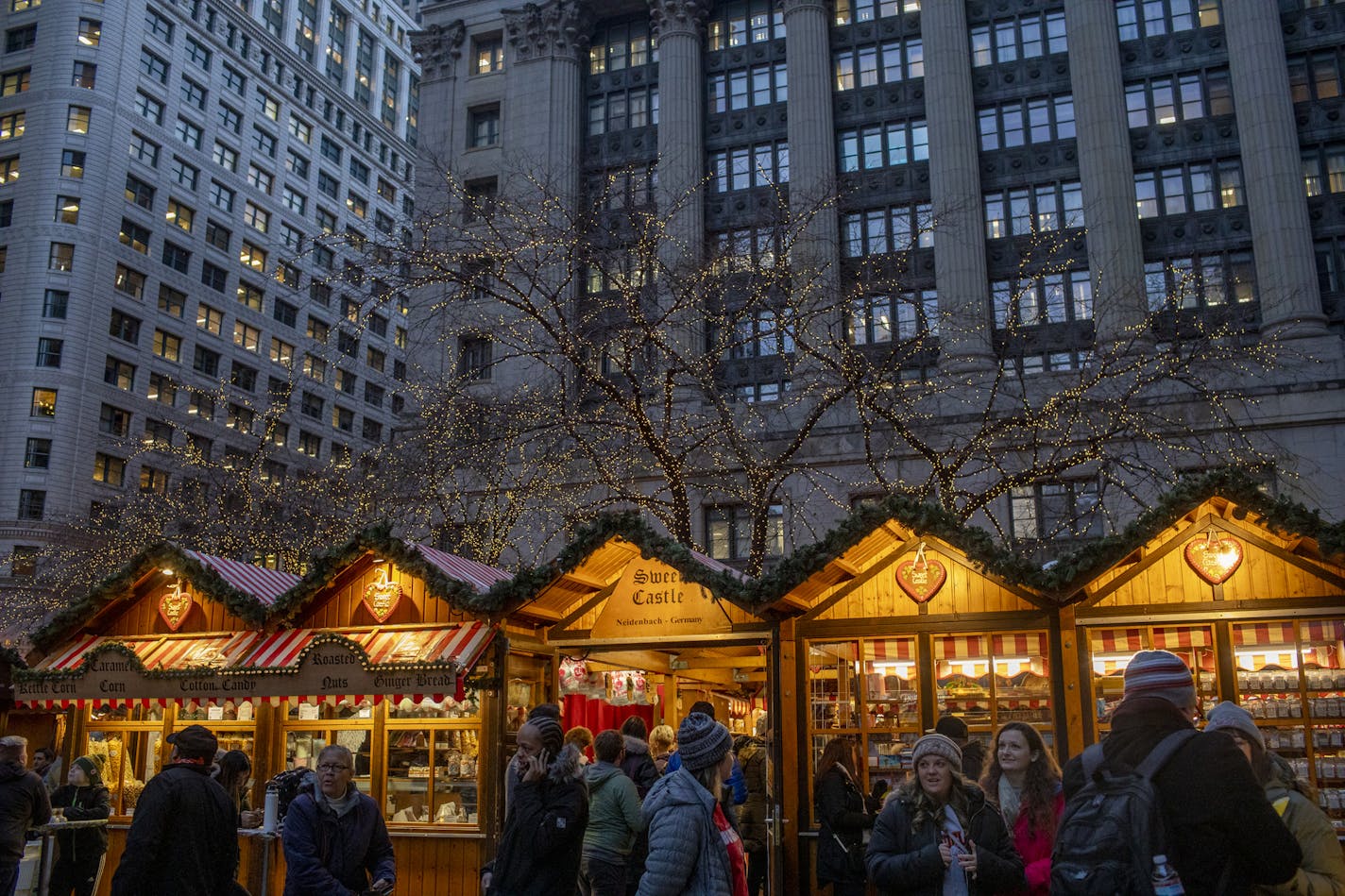 People walk around Daley Center Plaza on opening day of Christkindlmarket on Nov. 15, 2019 in Chicago. (Camille Fin /Chicago Tribune/TNS) ORG XMIT: 3092980