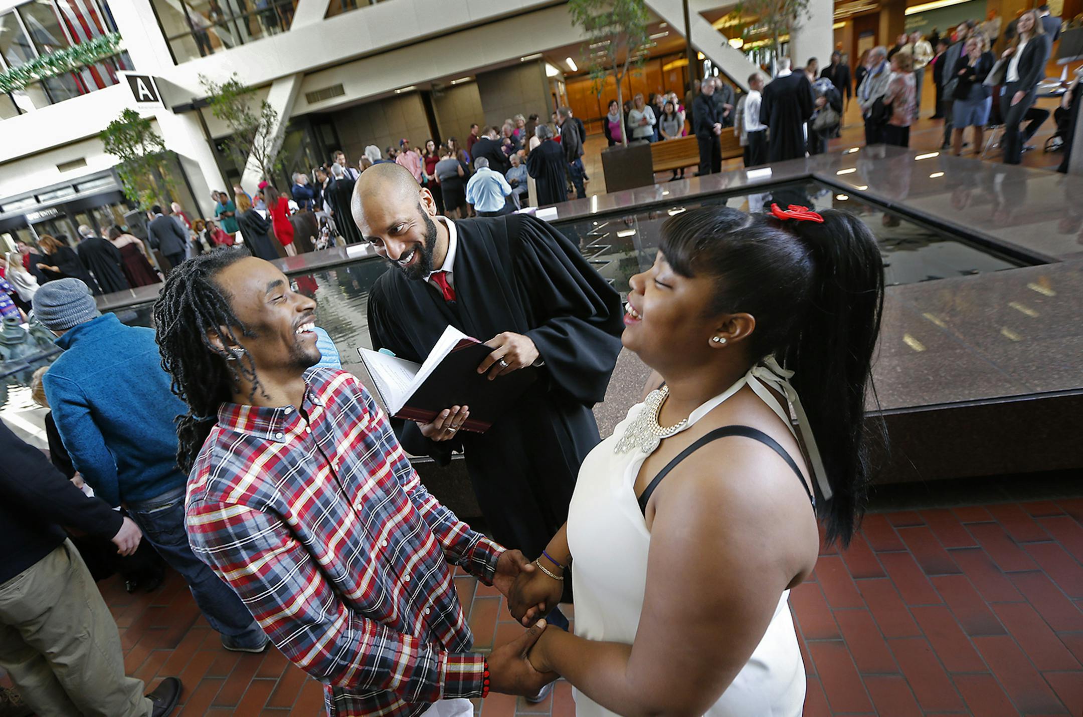 Naomi and Devante McHenry shared a laugh as Hennepin County 4th Judicial District Court judge Michael Browne performed the ceremony during the annual free wedding ceremony event at the Hennepin County Government Center, Tuesday, February 14, 2017 in Minneapolis, MN. Thirty-five couples exchanged vows. ] ELIZABETH FLORES &#xef; liz.flores@startribune.com