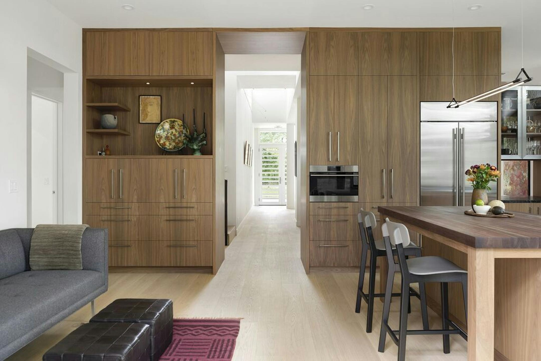 A wall of walnut cabinets create a focal point inside.