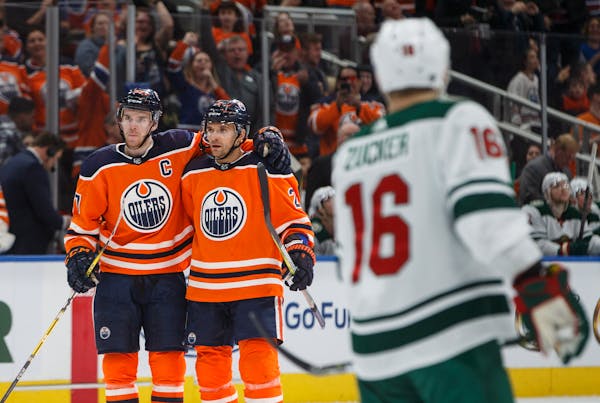 Edmonton Oilers center Connor McDavid (97) and defenseman Andrej Sekera (2) celebrated a goal against the Wild during their March 10 game.