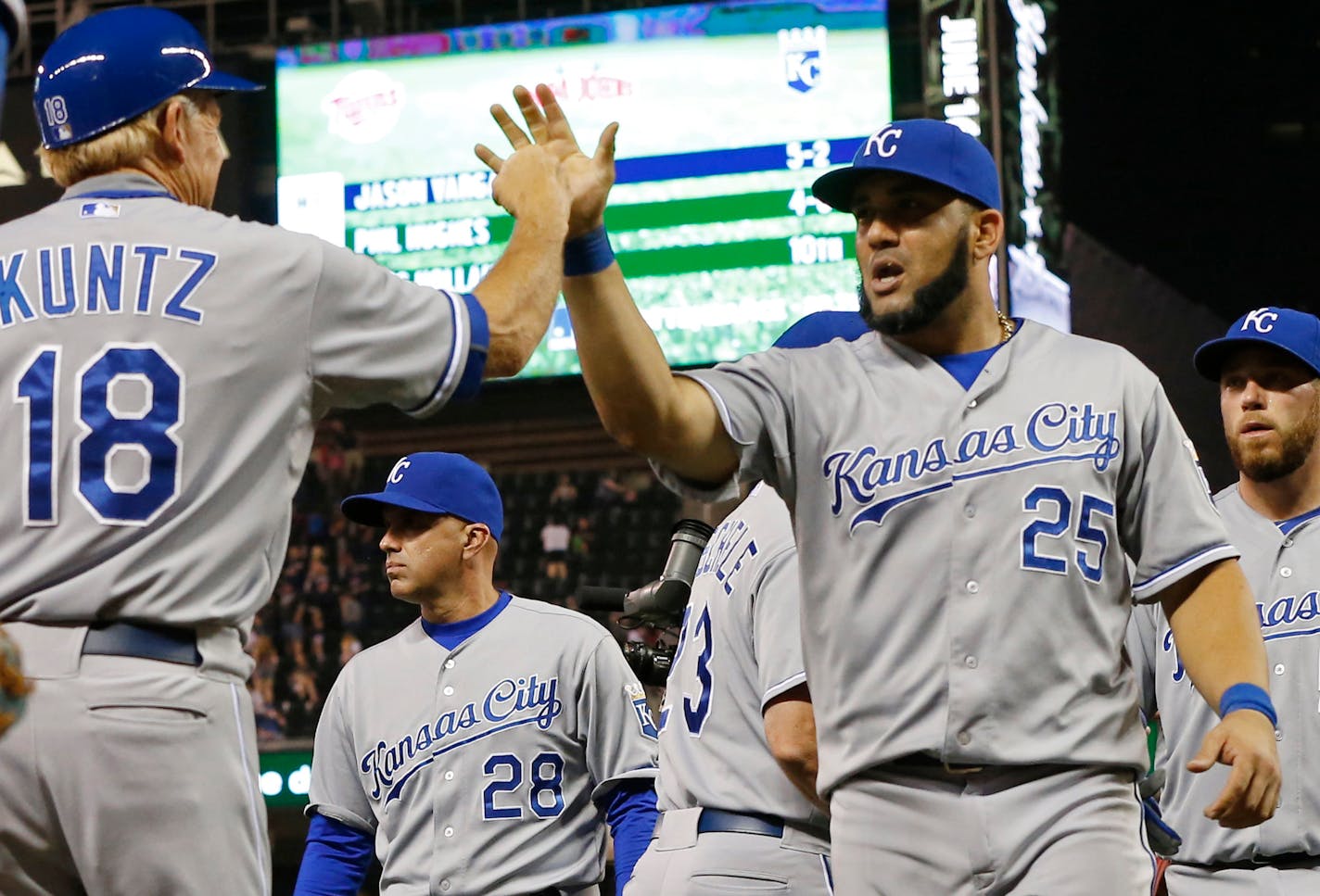 Royals designated hitter Kendrys Morales, right, high-fived first base coach Rusty Kuntz after the Royals defeated the Minnesota Twins 3-1 on Monday. Morales hit a two-run home run off Twins pitcher Phil Hughes in the second inning.