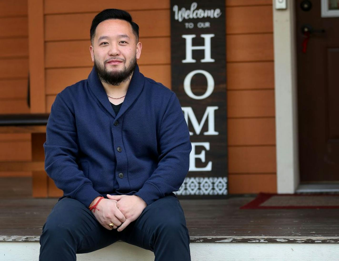 DFL Rep. Fue Lee, seen outside his North Minneapolis home on Sept. 16, said 20 members of his family came down with COVID-19 after a family wake last month.