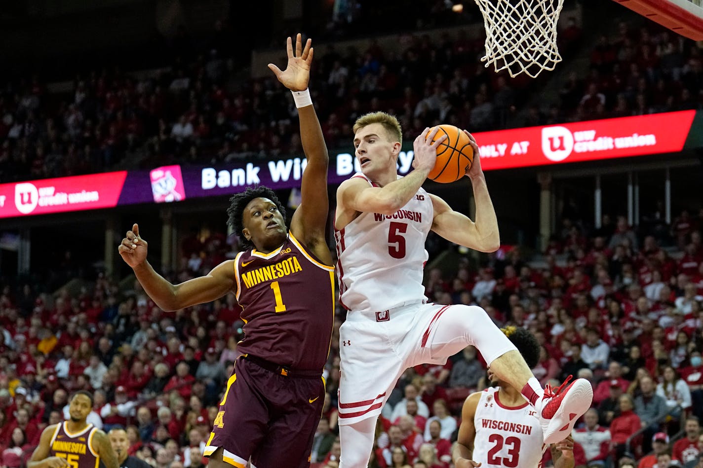 Wisconsin's Tyler Wahl (5) grabs a defensive rebound next to Minnesota's Joshua Ola-Joseph (1) during the first half of an NCAA college basketball game Tuesday, Jan. 3, 2023, in Madison, Wis. (AP Photo/Andy Manis)