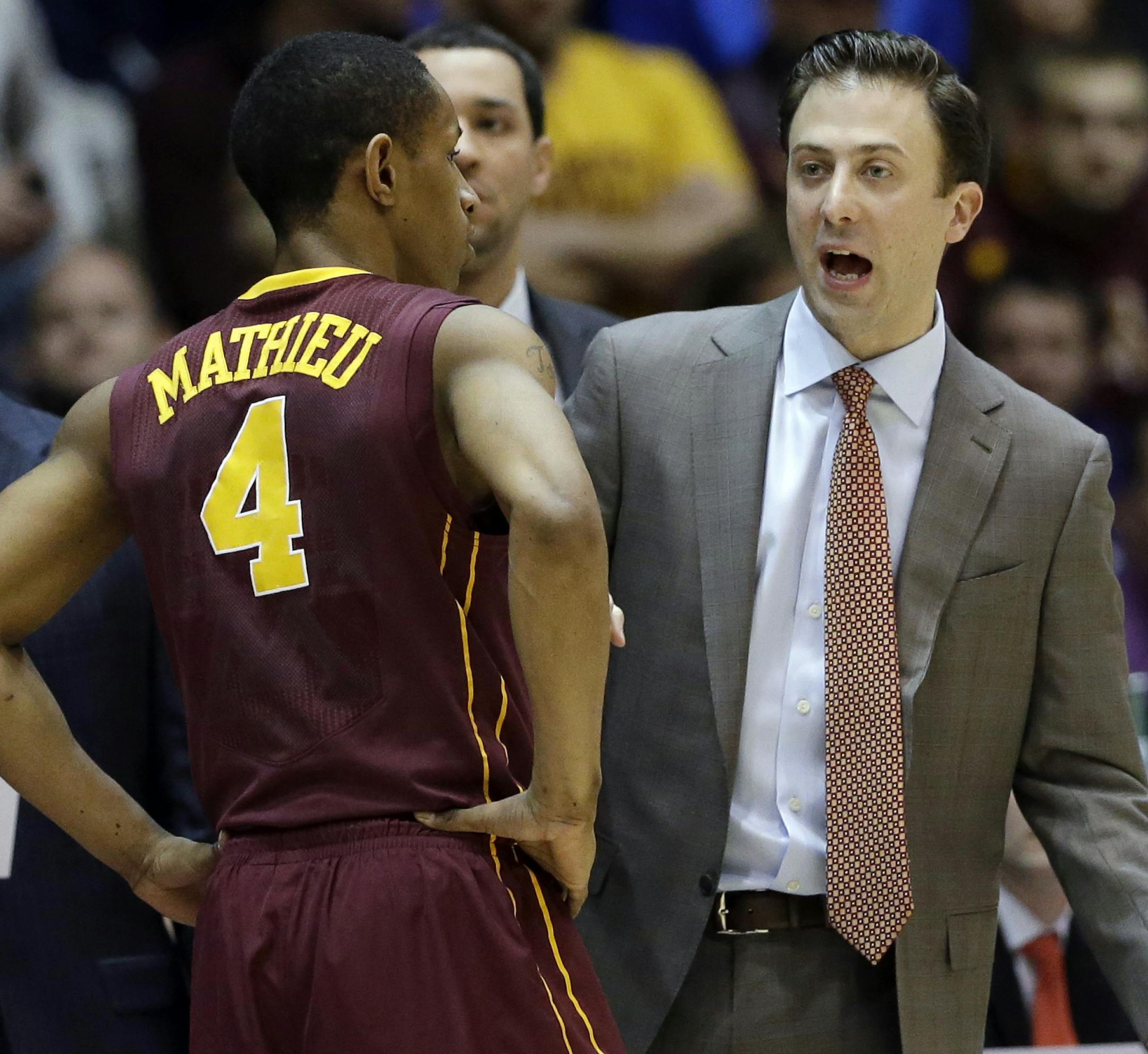 Minnesota head coach Richard Pitino, right, talks to guard DeAndre Mathieu (4) during the first half of an NCAA college basketball game against Northwestern in Evanston, Ill., Sunday, Feb. 16, 2014. (AP Photo/Nam Y. Huh)