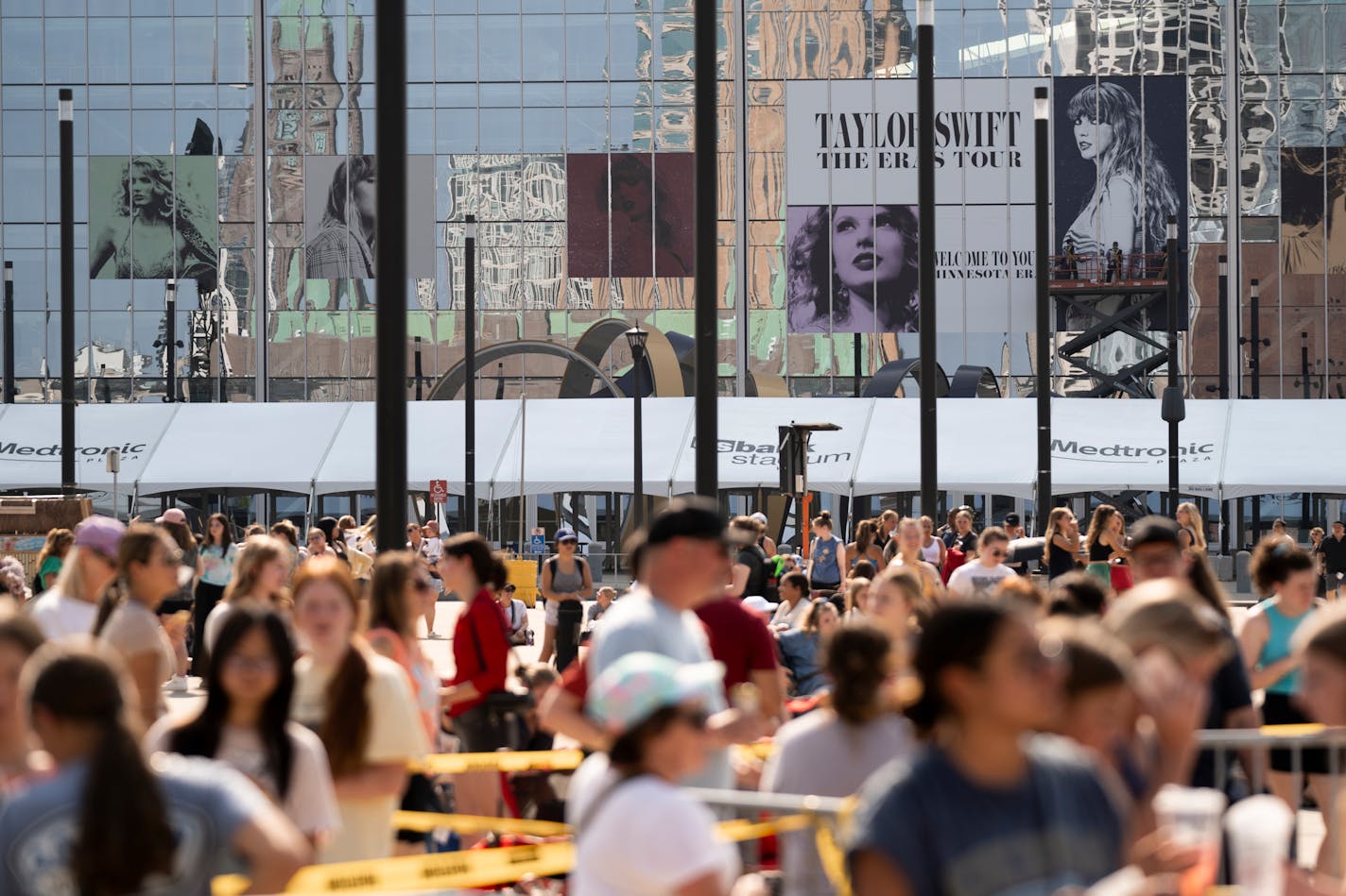 The U.S. Bank Stadium's Taylor Swift Eras Tour advertisements shine above the long merchandise line in Minneapolis, Minn., on Thursday, June 22, 2023. ] Angelina Katsanis • angelina.katsanis@startribune.com