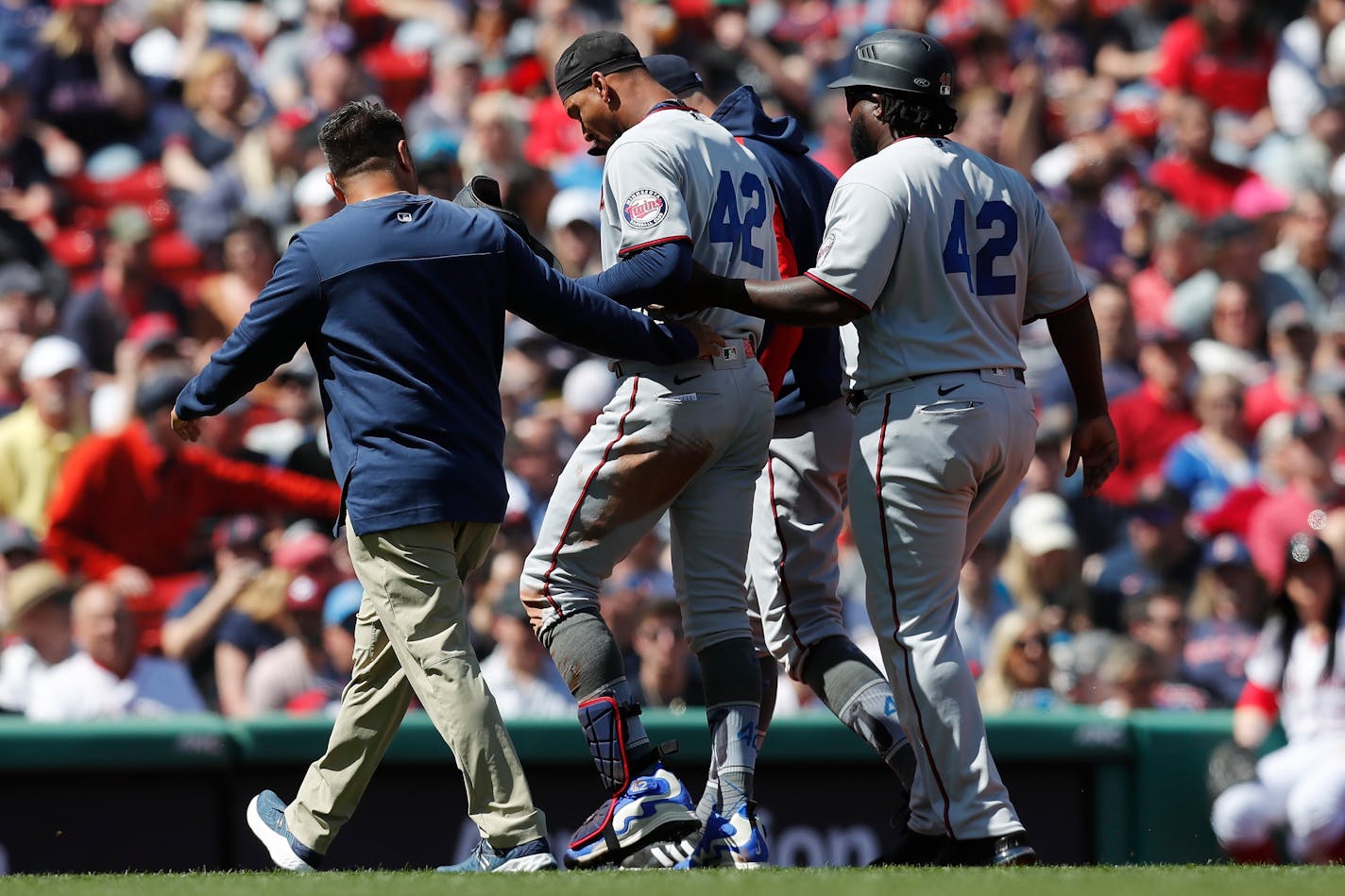 Minnesota Twins' Byron Buxton leaves the field after being injured on his double during the first inning Friday in Boston.