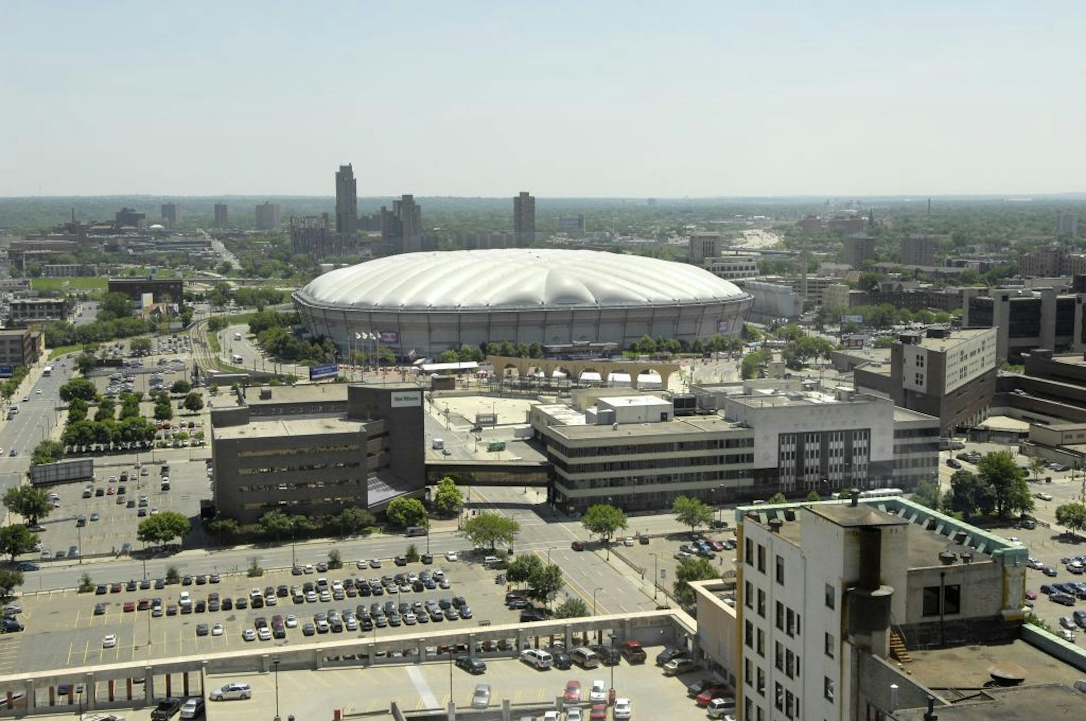 The Star Tribune Buildings on Portland Avenue and surrounding real estate are for sale. in the background is the Humphrey Metrodome. Star Tribune owners Avista. parking lots