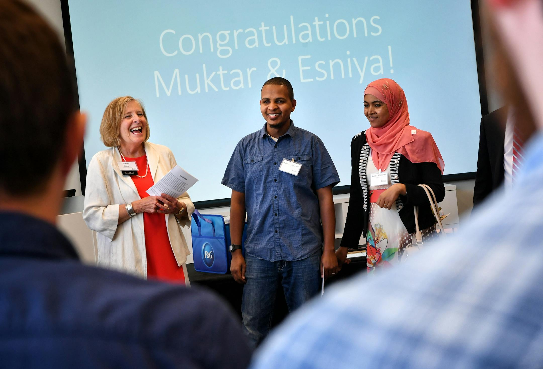 Sue Haigh, Habitat for Humanity president congratulated Muktar and Esniya Abasanbi on their new home ad a dedication ceremony for the first purchased through Habitat's new program. ] GLEN STUBBE ï glen.stubbe@startribune.com Wednesday May 31, 2017. Muktar Abasanbi, his wife and two young kids are the first family to buy a new home through Habitat For Humanity's new choice program. The excited family closes Wednesday. Habitat is aiming to double the number of families it matches with homes t