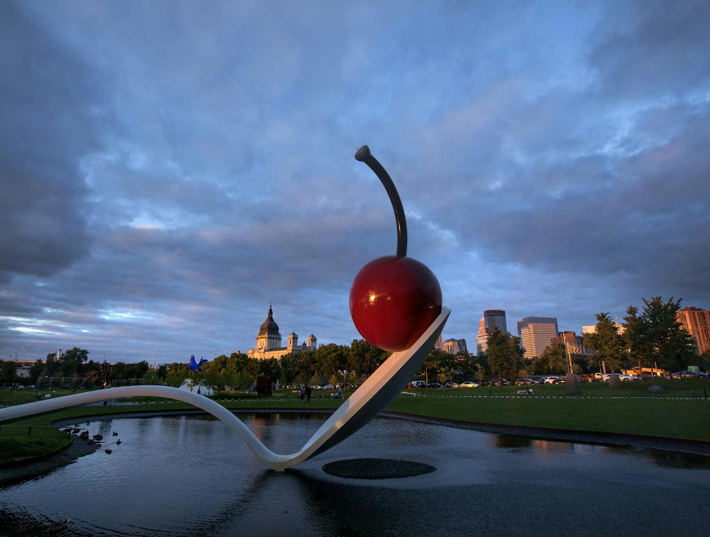 Iconic Minneapolis - Since 1985, a large spoon with a cherry suspended on the rim has come to represent parks and culture in Minneapolis. Water exits the cherry from both ends of the black cherry stem. Sculpture weighs approximately 7000 lbs.. With 11 landscaped acres showcasing more than 40 artworks, the Minneapolis Sculpture Garden unites two locally cherished resources: parks and culture. It is a partnership of the Park Board and the Walker Art Center. ] For 5 years running, Minneapolis park