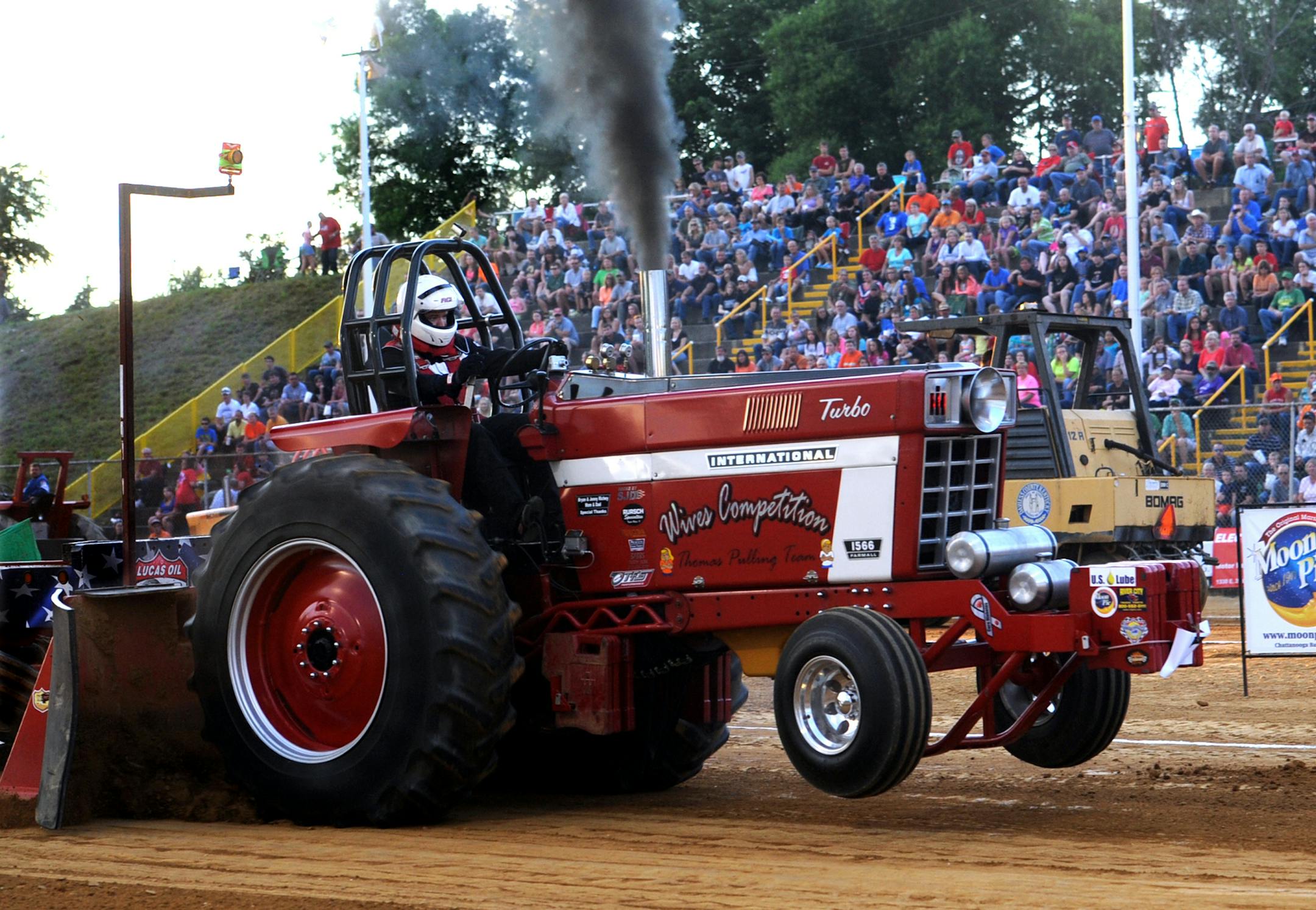 Laramy Thomas of Scottsburg, Ind. drives his International Harvester 1564 tractor into the lead in the Hot Farm division of the tractor pull competition Saturday in the Miles Arena at the Daviess County Lions Club Fair in Philpot. Thomas liked the track conditions. "It was a great run!" said Thomas who placed second in last year's pull. (AP Photo/Messenger-Inquirer, Gary Emord-Netzley) ORG XMIT: MIN2013081617155503