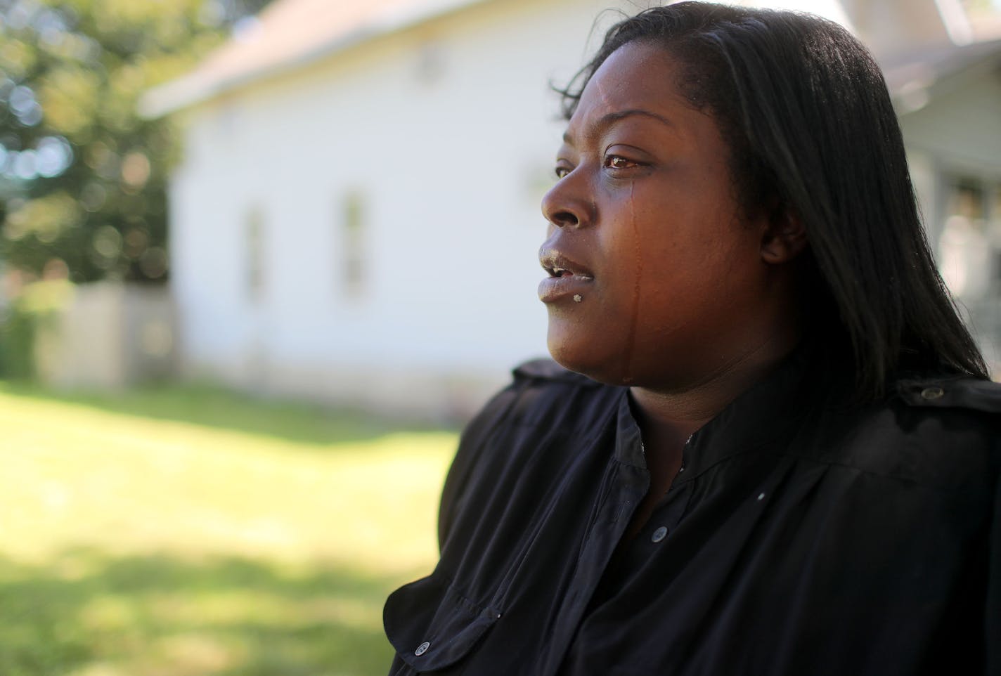 Marsha Mayes, the mother of 3-year-old Terrell Mayes, stand outside her former home where Terrell was killed in a drive-by shooting when a bullet pierced the blue vinyl-sided rental, fatally striking Terrell in 2012. Here, outside her former home, Mayes talked about the event and became emotional when talking about her healing process Friday, July 22, 2016, in Minneapolis, MN. ](DAVID JOLES/STARTRIBUNE)djoles@startribune.com Life is generally better these days on the 2600 block of Colfax Avenue