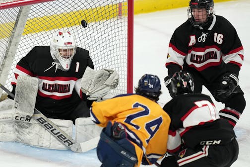 Mahtomedi forward Corey Bohmert (24) scores on Alexandria goaltender Elijah Rasmusen (1) in the first period of a MSHSL Class 1A quarterfinal hockey game between Alexandria and Mahtomedi.