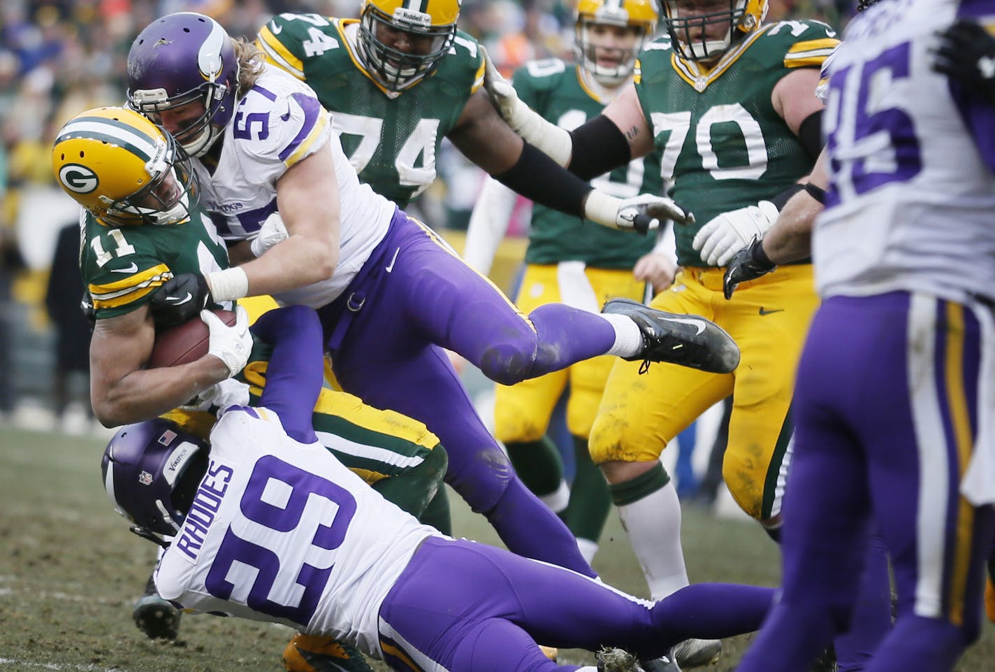 Green Bay Packers wide receiver Jarrett Boykin was stopped by Minnesota Vikings linebacker Audie Cole (57) and Xavier Rhodes (29) short of a fist down in the fourth quarter during NFL action between the Minnesota Vikings and the Green Bay Packers at Lambeau Field Sunday November 24.