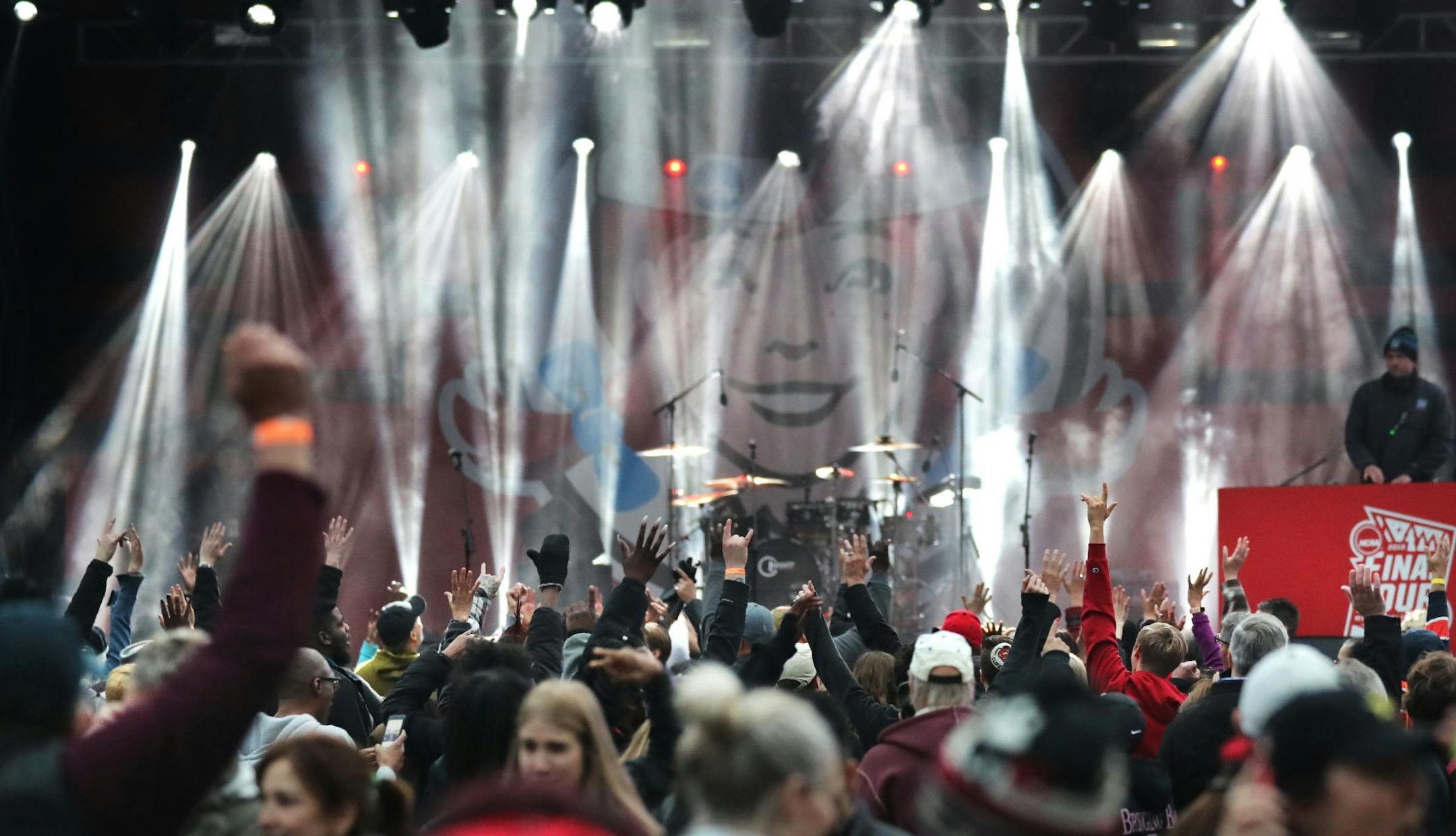 Hands shoot up in the air at the music stage when the MC asks who in the crowd is from the Twin Cities at the Tip-Off Tailgate Friday, April 5, 2019, on the Nicollet Mall in Minneapolis, MN.