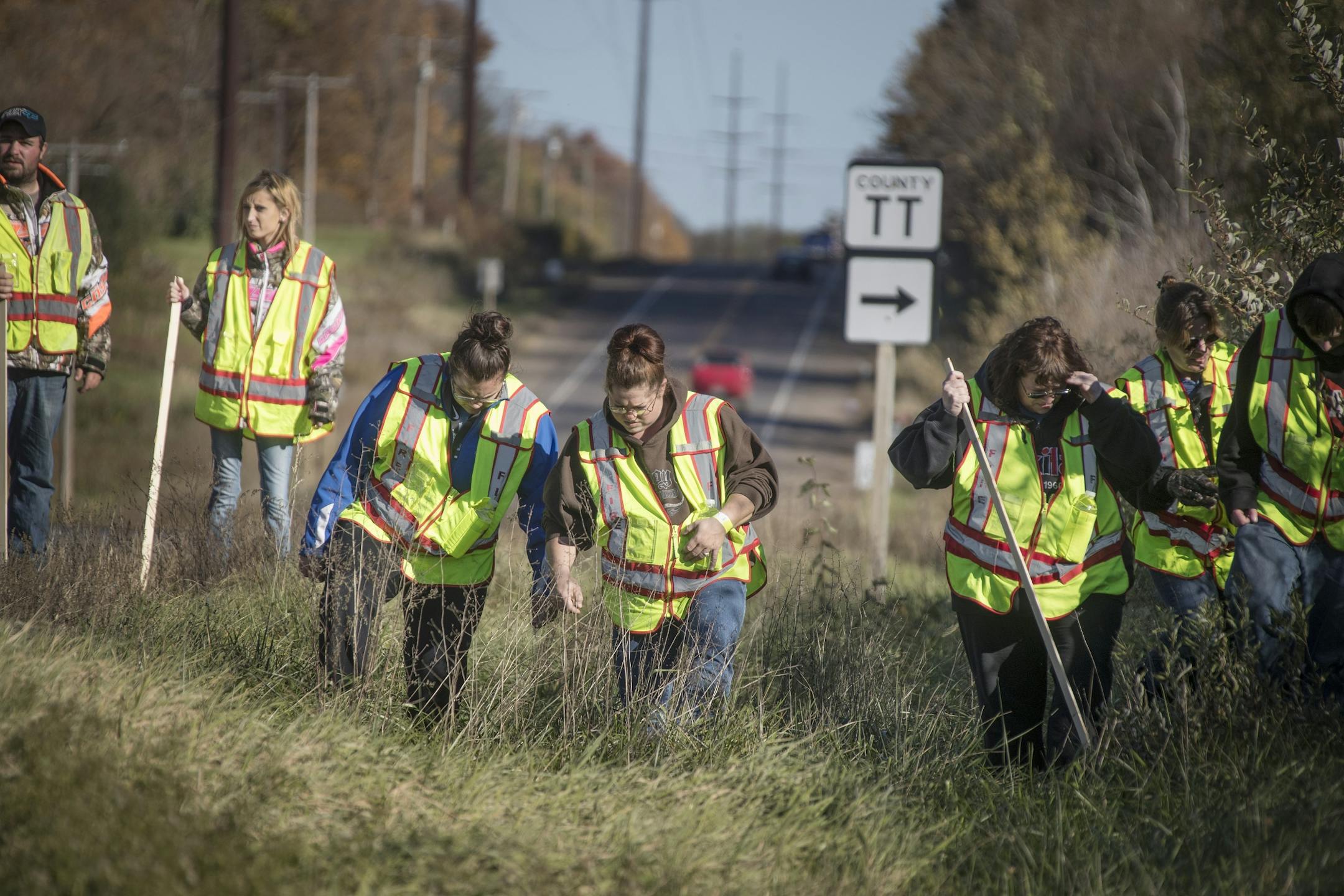 A group of volunteers searched the ditches along highway 8 in near the home where 13-year-old Jayme Closs lived with her parents James, and Denise, on Thursday, Oct. 18, 2018 in Barron, Wis.