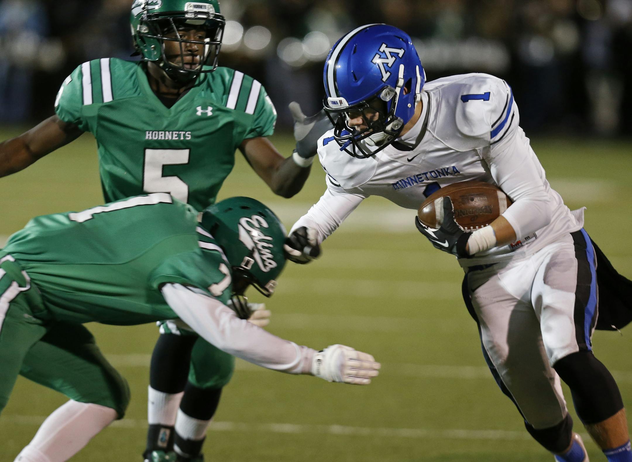 At Kuhlman Field in Edina, in the class 6A football playoff game between Edina and Minnetonka High Schools, Joseph Smith(5) and Jack Dummer(7) sought to bring down Braden Sikes(1) of Minnetonka in the first quarter.]richard tsong-taatarii/rtsongtaataarii@startribune.com