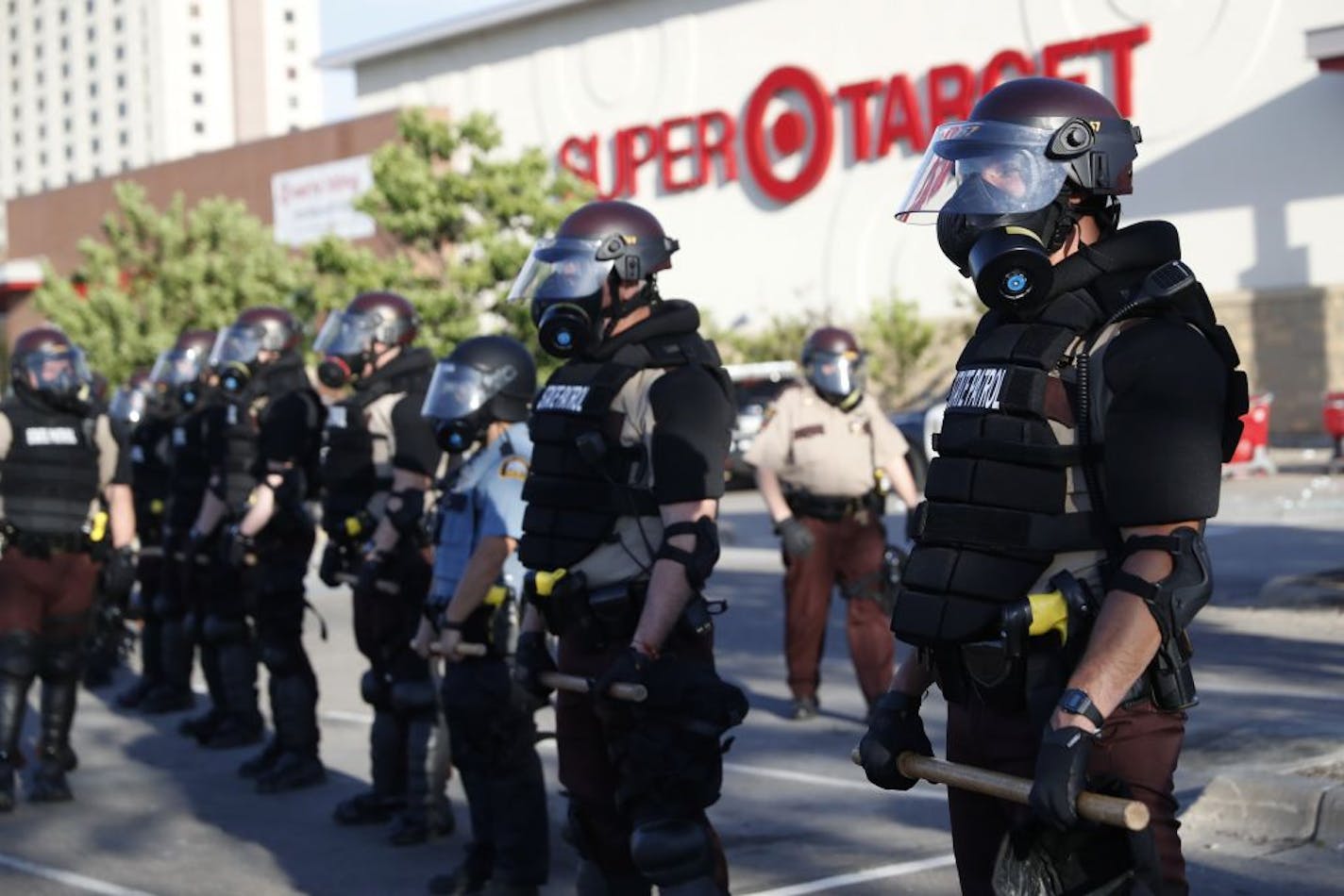 Minnesota State Police protect a Target Store Thursday, May 28, 2020, in St. Paul, Minn. Violent protests over the death of George Floyd, the black man in police custody broke out in Minneapolis for a second straight night Wednesday, with protesters in a standoff with officers outside a police precinct and looting of nearby stores.