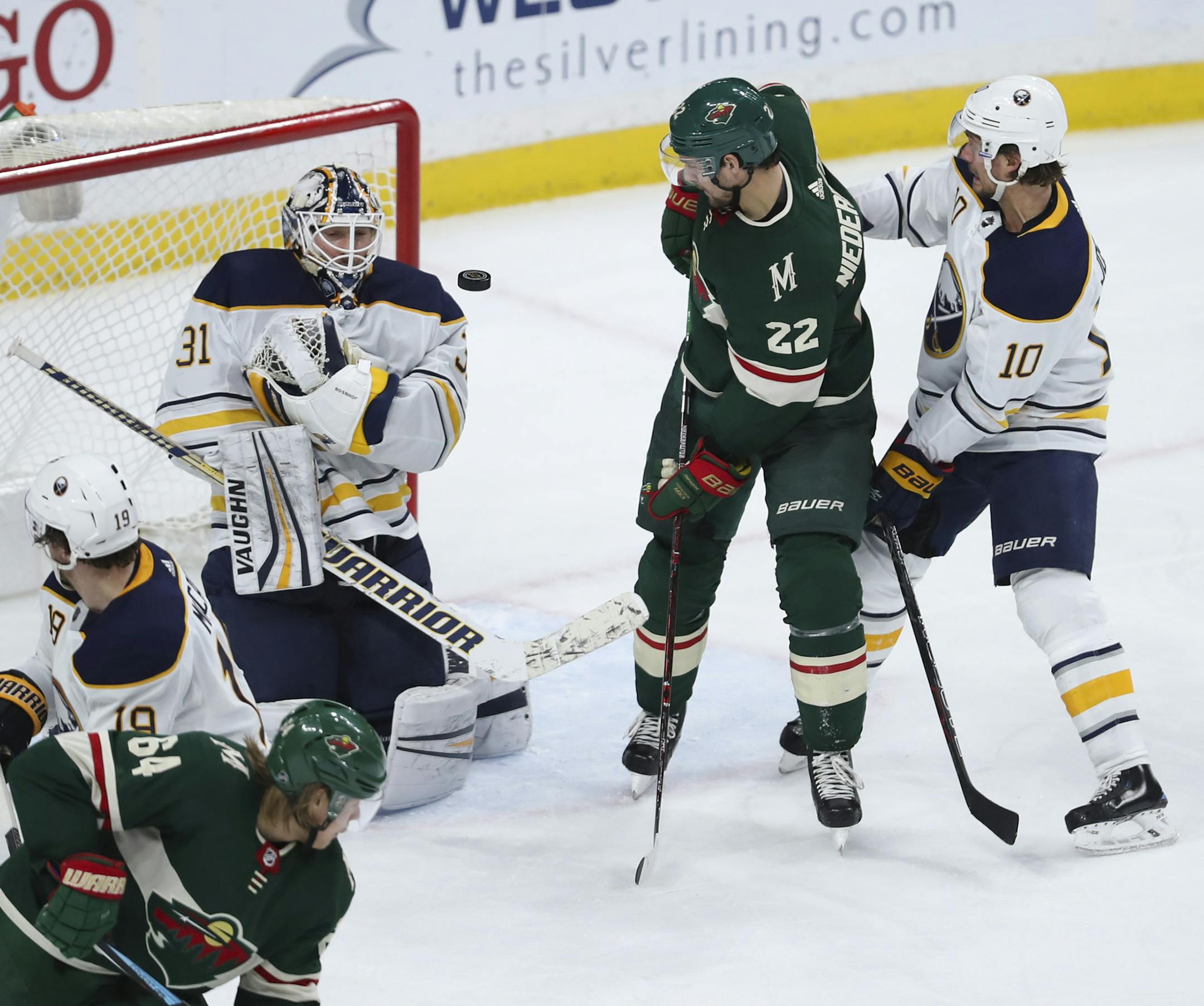 After already earning a hat trick in the second period, Minnesota right wing Nino Niederreiter (22) looked for the rebound off Buffalo Sabres goaltender Chad Johnson while he defended by Buffalo center Jacob Josefson (10) in the third period. ] JEFF WHEELER ï jeff.wheeler@startribune.com The Minnesota Wild dulled the Buffalo Sabres 6-2 in an NHL hockey game Thursday night, January 4, 2018 at Xcel Energy Center in St. Paul.