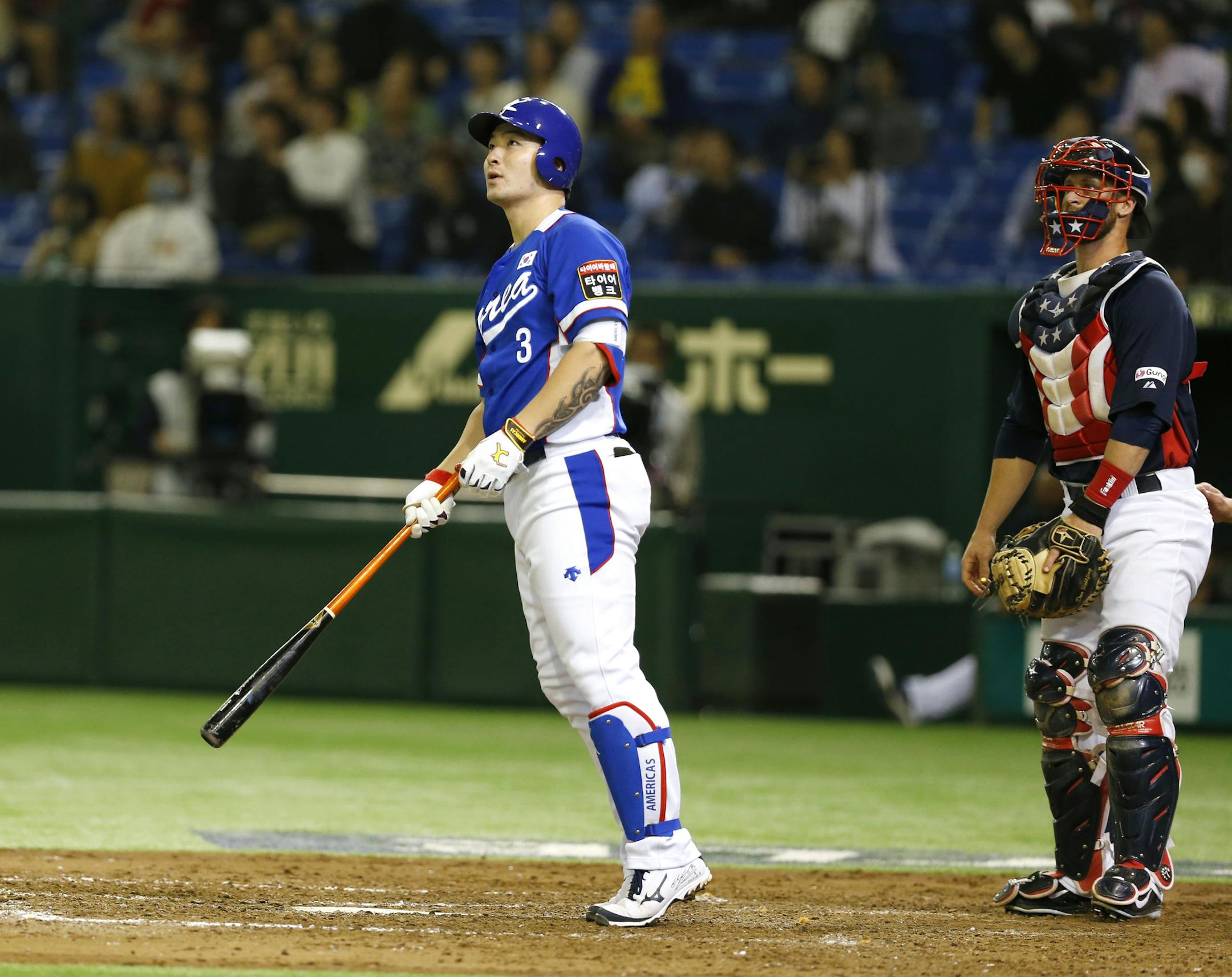South Korea&#x2019;s Park Byung-ho watches the flight of his three-run home run with USA catcher Dan Rohlfing in the fourth inning of their final game at the Premier12 world baseball tournament at Tokyo Dome in Tokyo, Saturday, Nov. 21, 2015.